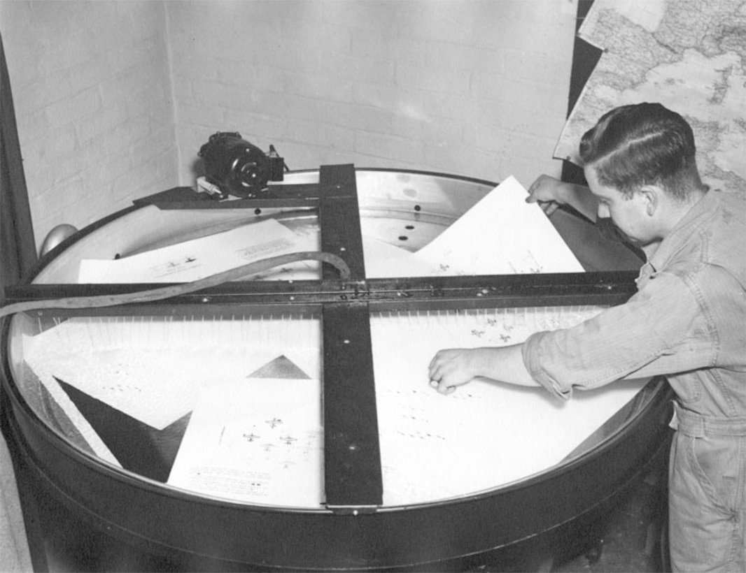 Photo specialist washes prints in film bath