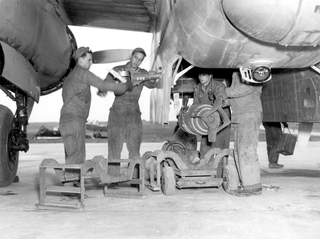 Weaponeers load bombs into a B-26