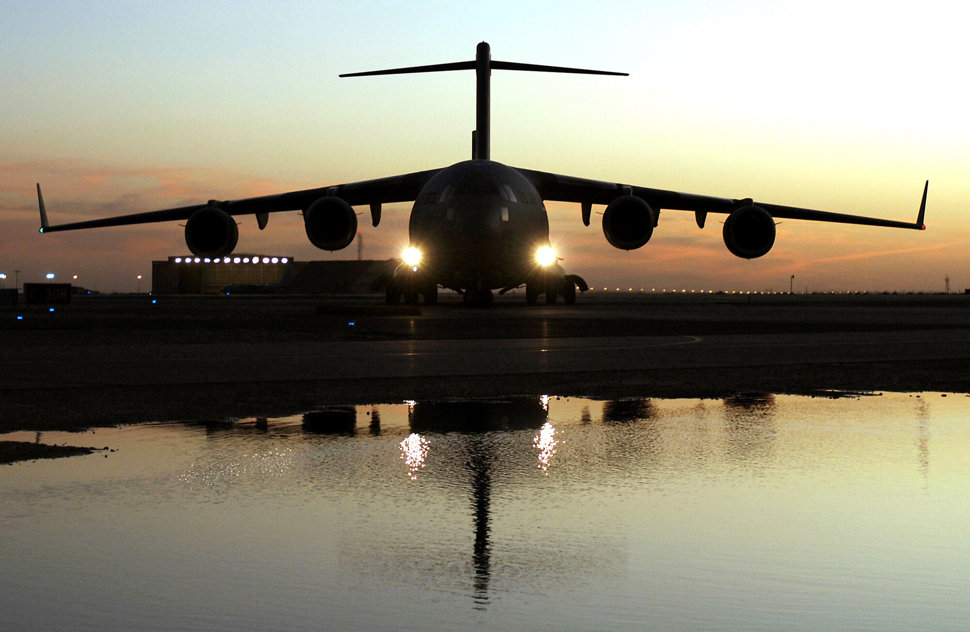 Crewmembers aboard a C-17 Globemaster III aircraft prepare to offload wounded personnel from Balad Air Base, Iraq, at an undisclosed location in Southwest Asia. (U.S. Air Force photo/Staff Sgt. Edward D. Holzapfel) 