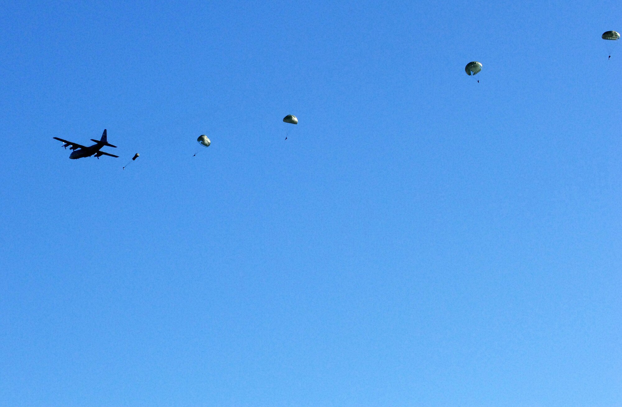 FORT HOOD, Texas -- A Dyess C-130 drops personnel over the Recondo Drop Zone during the first airborne operation here in more than 10 years. (U.S. Army photo by Cpl. John Ortiz)