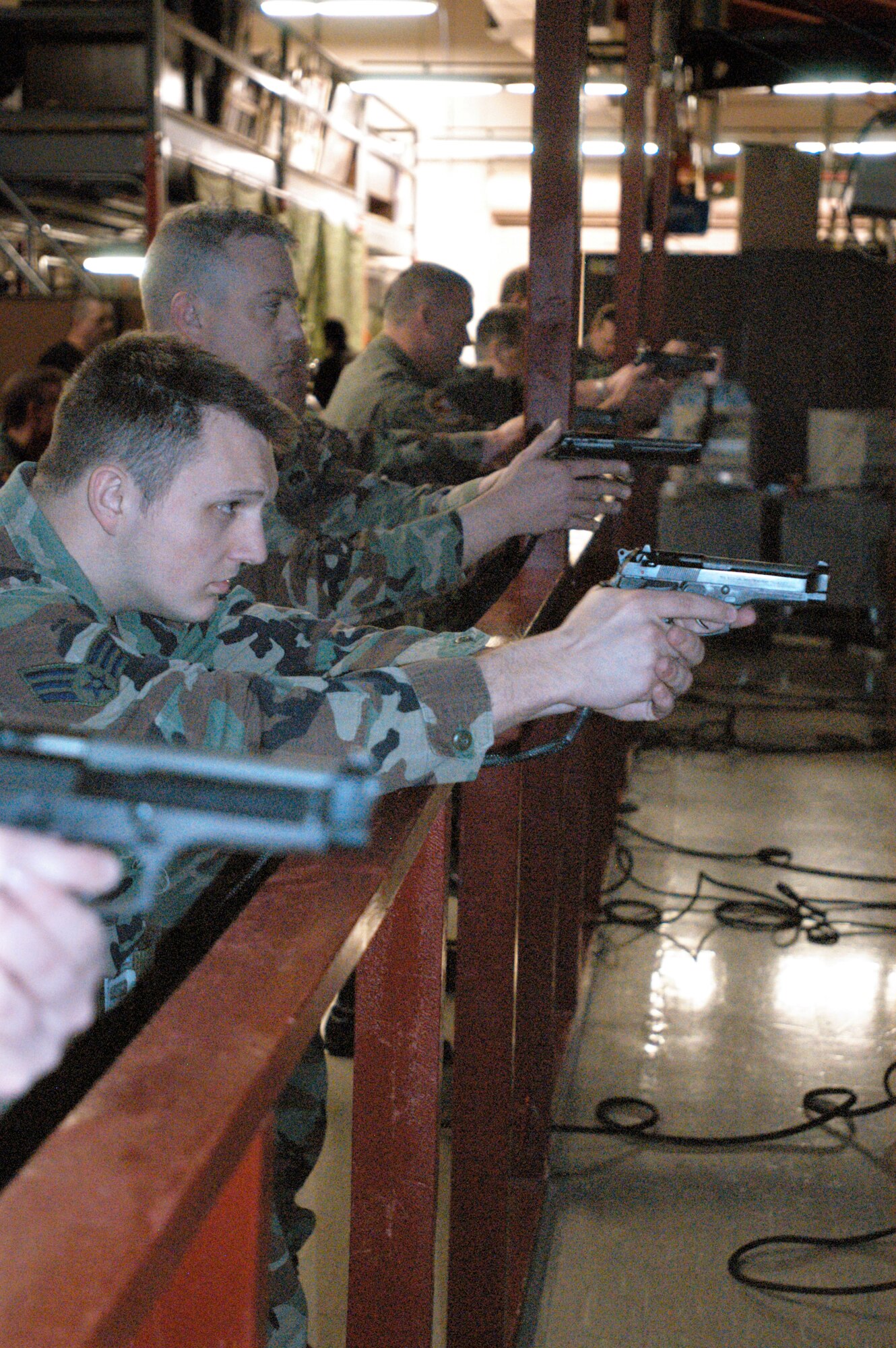 GRISSOM AIR RESERVE BASE, Ind., -- The fire arms training simulator, located in the 434th Security Forces building, is used when inclement weather conditions permit personnel from using the firing range for weapons qualification. During the March unit training assembly Senior Airman, 434th Maintenance Squadron fabric worker, sets his eyes on the target during his M-9 qualification. (U.S. Air Force photo/Senior Airman Carl Berry)