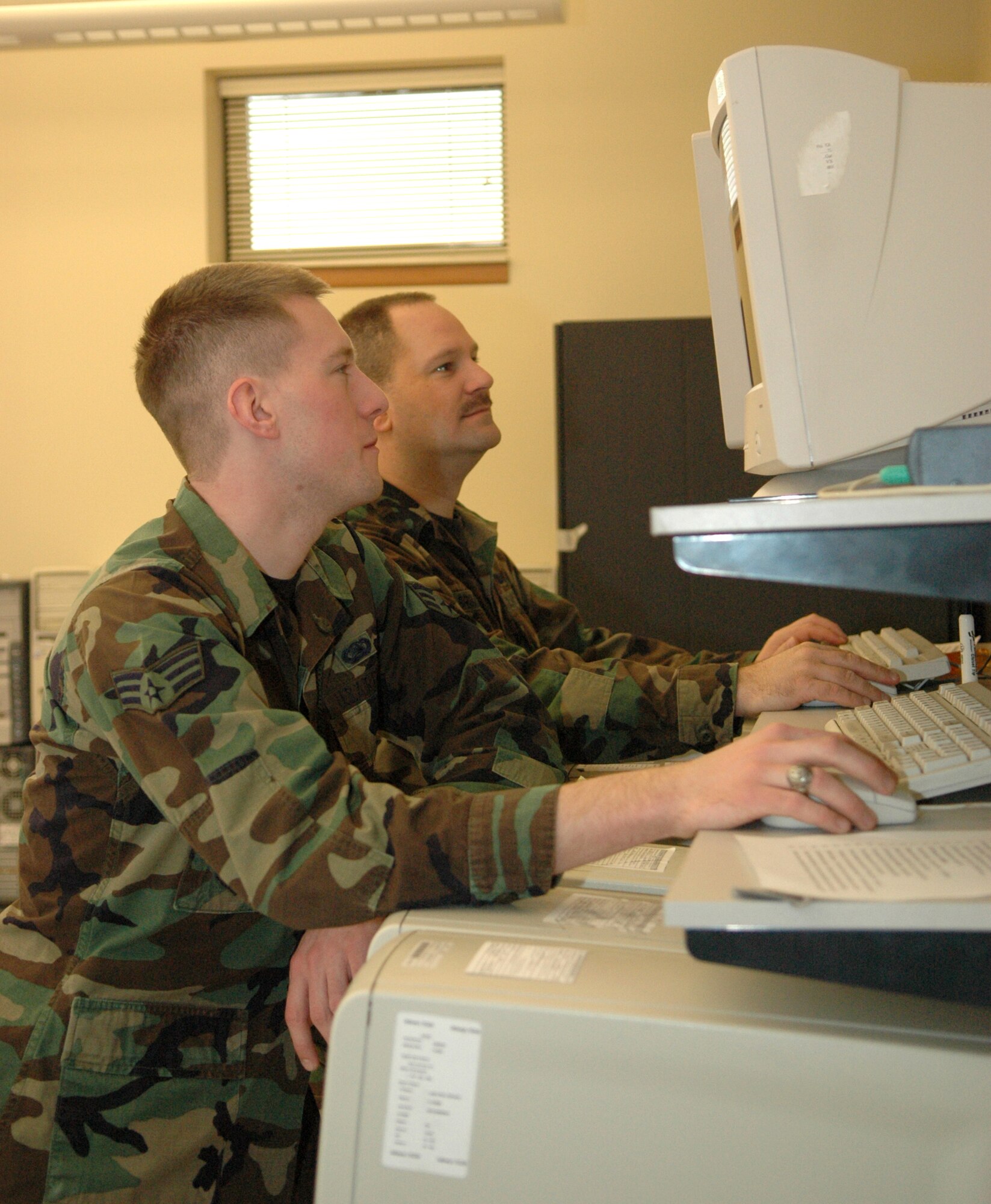 GRISSOM AIR RESERVE BASE, Ind., -- Staff Sgt. Rich Brimer and SrA. Andrew Vernum, both computer systems operators with the 434th Communications Squadron, clean the hard drives of old DOD computers.  The computers will then be donated to local schools. (U.S. Air Force photo/Senior Airman Ben Mota)