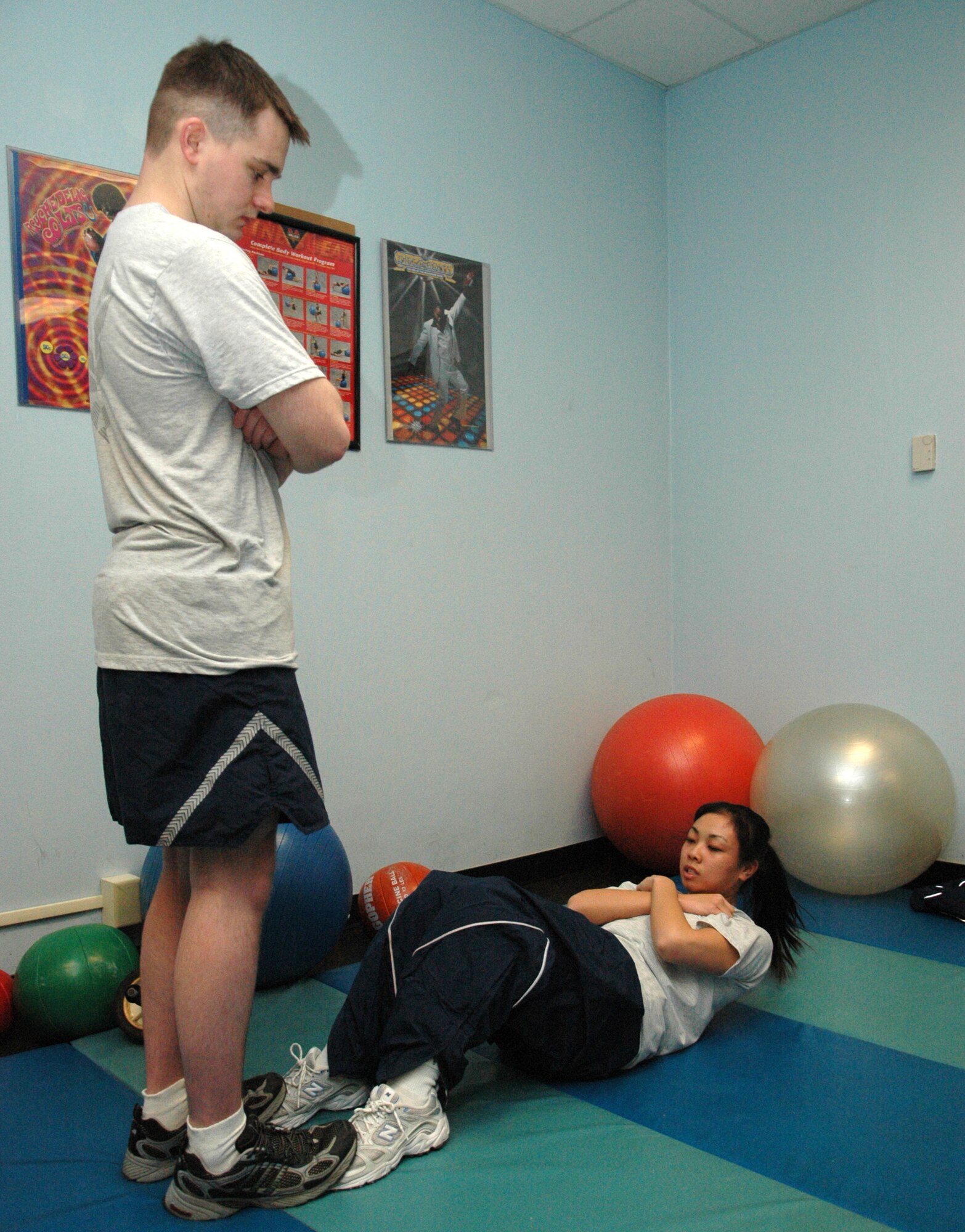 GRISSOM AIR RESERVE BASE, Ind., -- Staff Sgt. Lu Chichi, a computer systems operator with the 434th Communications Squadron, performs sit-ups for her fitness test while Staff Sgt. Daniel Hutchinson, also a computer systems operator, assists. (U.S. Air Force photo/Senior Airman Ben Mota)