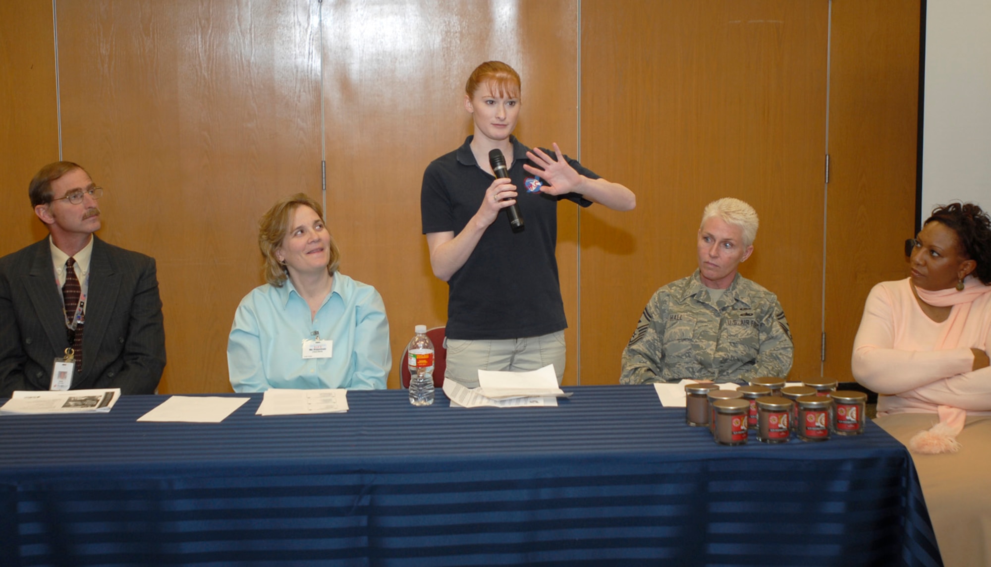 Senior Master Sgt. Treassia Hall, North American Aerospace Defense Command/U.S. Northern Command first sergeant, talks to spouses about Peterson's First Sergeants Association at the Spouses Town Hall Mar. 3. Representatives from various agencies on base talked to dozens of spouses at the meeting about the services Peterson offers for Airmen and their families. (U.S. Air Force photo/Corey Dahl)
