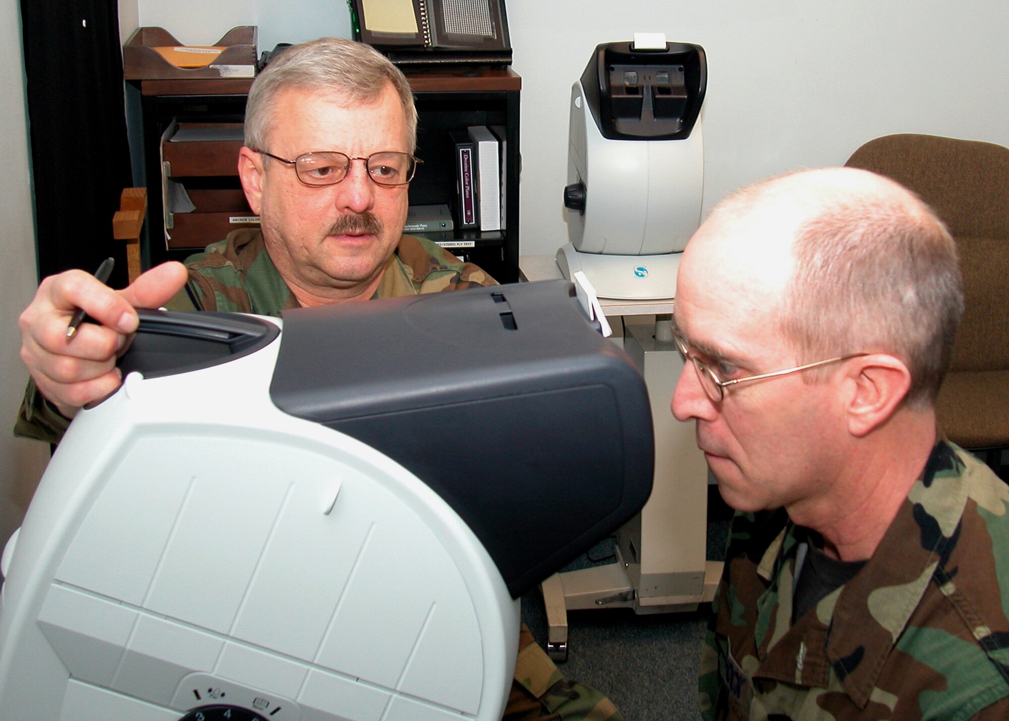 GRISSOM AIR RESERVE BASE, Ind., -- Master Sgt. Ed Lampa, NCOIC of the 434th Aerospace Medicine Squadron optical clinic, administers an eye test to Master Sgt. Chris Schock, 434th  Maintenance Squadron, fuels shop chief during a unit training assembly. (Air Force photo/Senior Airman Chris Bolen)