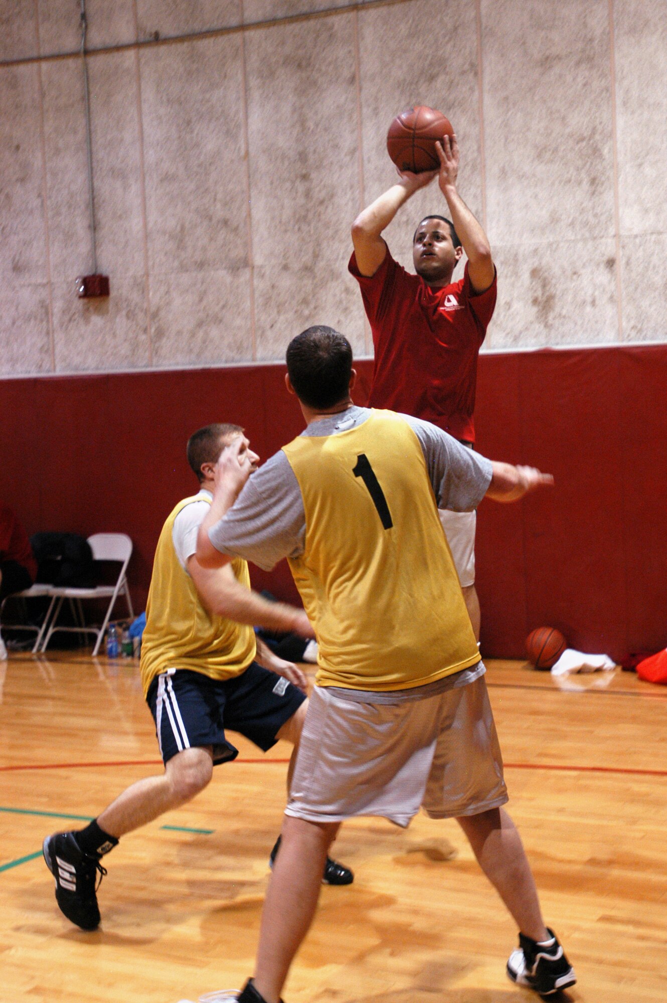 GRISSOM AIR RESERVE BASE Ind. -- Carl Berry, a shooting guard with the DOD Police team, elevates above his opponents while taking a jump shot against Ops during the final round of the annual Grissom basketball tournament. Berry and his team over shot their competition, securing the championship title.  The basketball tournament is just one of a number of special sporting events sponsored each year by the 434th Services Flight and Fitness Center.  (U.S. Air Force photo/Staff Sgt. Mark R. W. Orders-Woempner)