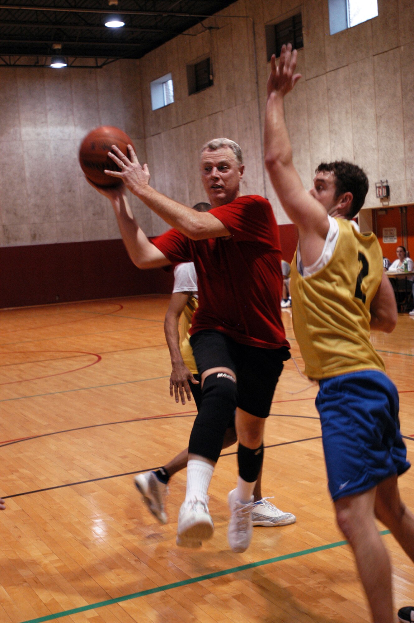 GRISSOM AIR RESERVE BASE Ind. -- Tim Spangler, DoD Police forward, blazes through the lane, breaking up the defense against Ops during the Grissom Basketball Tournament Final Four March 1. Spangler and his team burned out the competition, securing the championship title. (U.S. Air Force photo/Staff Sgt. Mark R. W. Orders-Woempner)