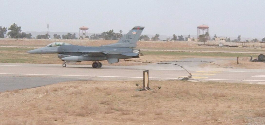 KIRKUK REGIONAL AIR BASE, Iraq -- An F-16 Fighting Falcon pilot tests the strength of a Mobile Aircraft Arresting System cable during a barrier engagement test Feb. 28 here. The MAAS is designed to reduce the forward energy of a fighter aircraft during an emergency landing. 

The MAAS consists of twin platforms connecting a cable that runs across the runway. During an emergency landing, a fighter pilot can drop a hook that latches onto the MAAS cable. The connection reduces the forward energy of the fighter aircraft which cushions impact. Though no fighters are assigned to Kirkuk, these aircraft could be diverted here for reasons ranging from bad weather to mechanical problems. The barrier engagement involved efforts from the 506th Expeditionary Operations Support Squadron, Civil Engineer Squadron, Logistics Readiness Squadron, Security Forces Squadron and Communication Squadron. The two F-16s that participated in the engagement were from the 421st Expeditionary Fighter Squadron. (U.S. Air Force photo by Maj. Stephen Miceli)