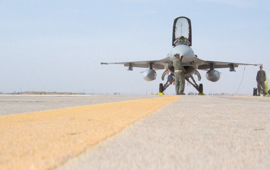 KIRKUK REGIONAL AIR BASE, Iraq -- An F-16 Fighting Falcon pilot prepares to take off during a barrier engagement exercise Feb. 28 here. The barrier engagement tests the Mobile Aircraft Arresting System, which is designed to reduce the forward energy of a fighter aircraft during an emergency landing. 

The MAAS consists of twin platforms connecting a cable that runs across the runway. During an emergency landing, a fighter pilot can drop a hook that latches onto the MAAS cable. The connection reduces the forward energy of the fighter aircraft which cushions impact. Though no fighters are assigned to Kirkuk, these aircraft could be diverted here for reasons ranging from bad weather to mechanical problems. The barrier engagement involved efforts from the 506th Expeditionary Operations Support Squadron, Civil Engineer Squadron, Logistics Readiness Squadron, Security Forces Squadron and Communication Squadron. The two F-16s that participated in the engagement were from the 421st Expeditionary Fighter Squadron. (U.S. Air Force photo by Maj. Stephen Miceli)