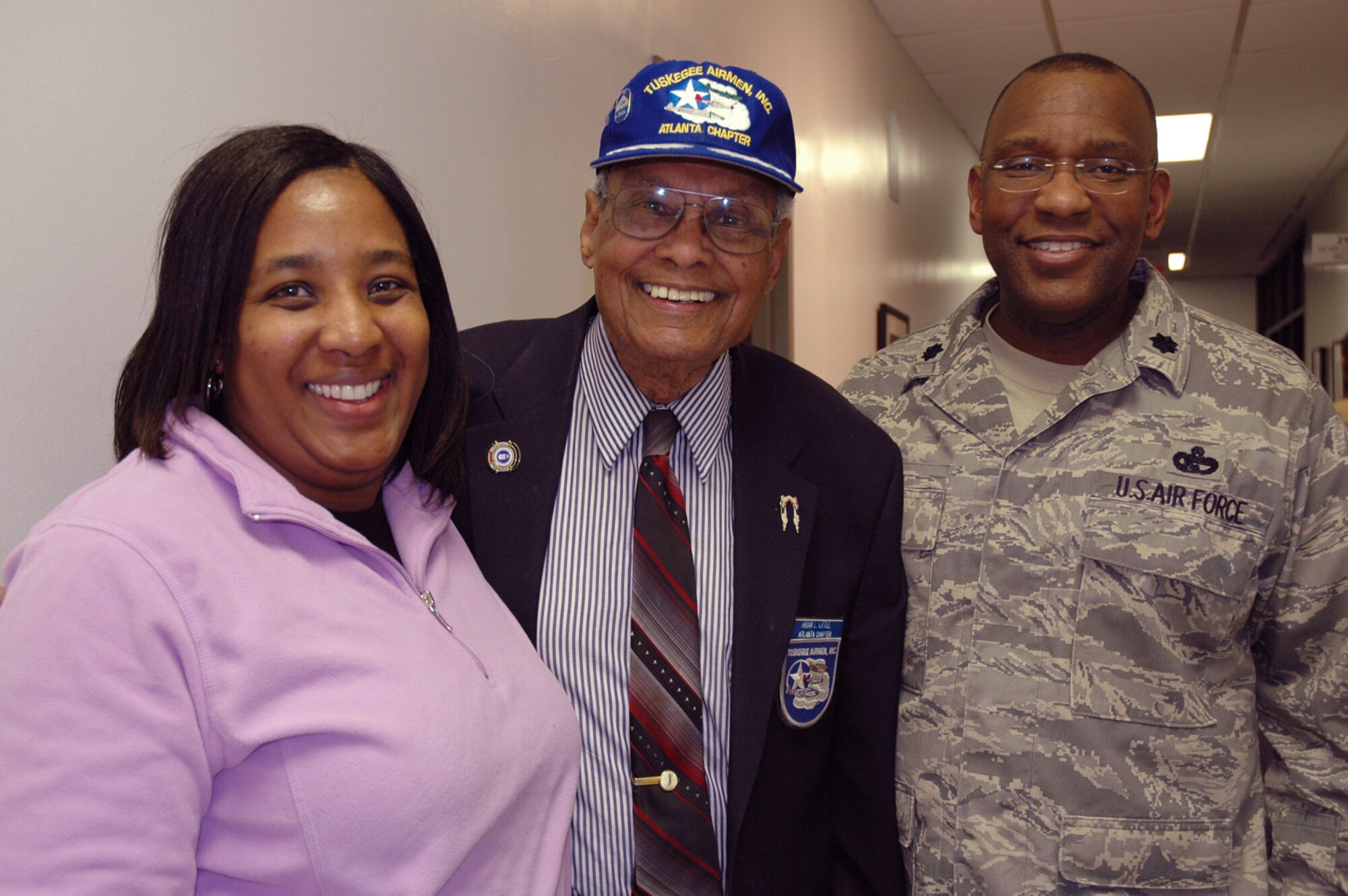 Mr. Hiram A. Little, one of the original Tuskegee Airmen visited Dobbins Air Reserve Base Friday, and is stopped for a picture with Andrea Lard, and Lt. Col. Marshall Irvin, of the 94th Mission Support Group here. Mr. Little installed and maintained weapons systems on fighter aircraft and later became a navigator-bombardier as a crew member and flight officer on the B-25 Bomber, assigned to the 477th Bomber Group. Mr. little is one of several Tuskegee Airmen who live in the region and continue to support programs and activities on Dobbins Air Reserve Base. The building this picture was taken in is one block away from the base's own "Tuskegee Airmen Avenue." U.S. Air Force photo/Staff Sgt. Micah Garbarino)