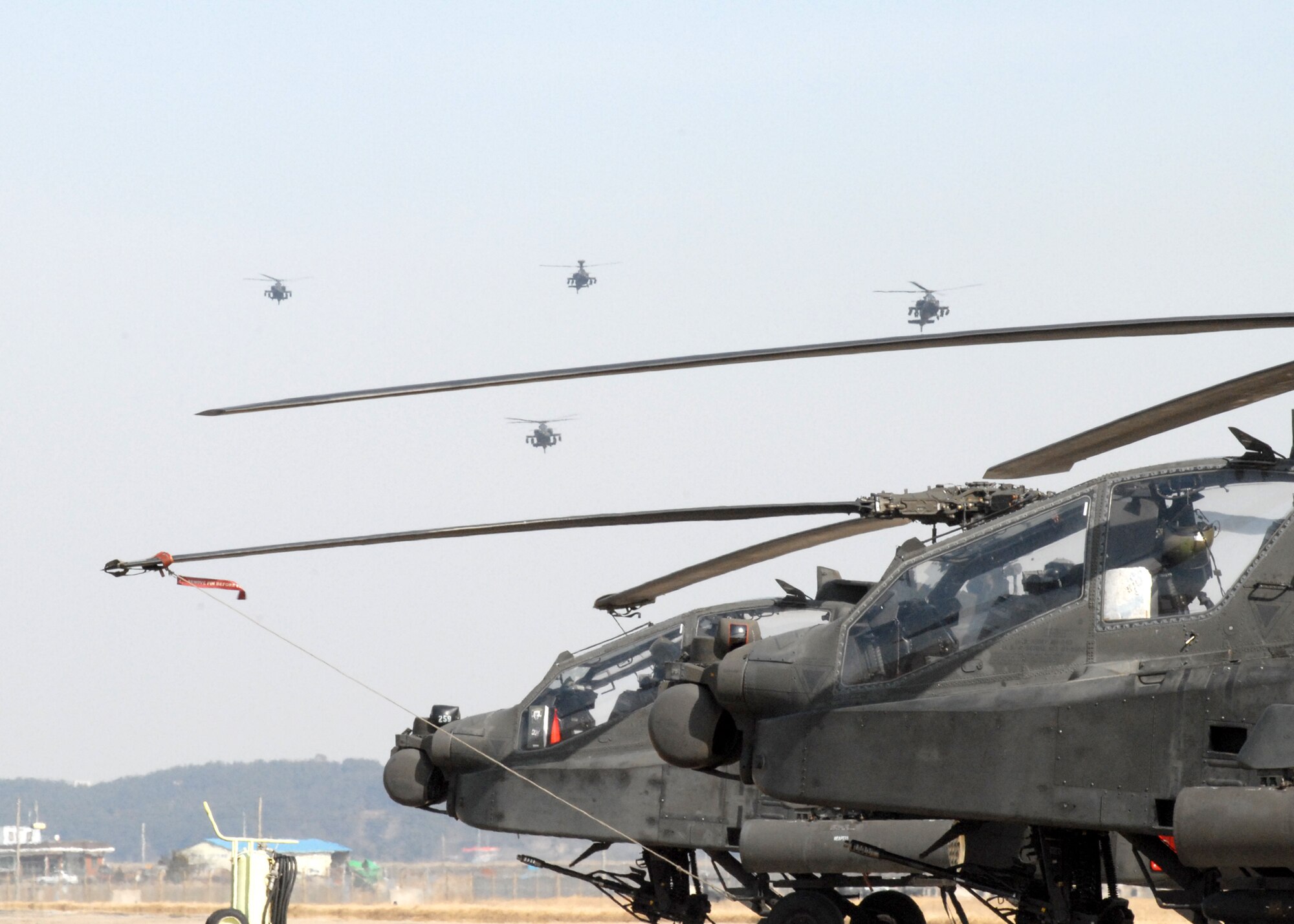 KUNSAN AIR BASE, South Korea -- AH-64 Apache helicopters arrive here Mar. 1.  The Apache's arrived from Camp Humphrey's, Bravo Company 4-2, as part of the Key Resolve/Foal Eagle exercise, enhancing combat readiness and joint interoperability.  (U.S. Air Force Photo/Staff Sgt Araceli Alarcon) 