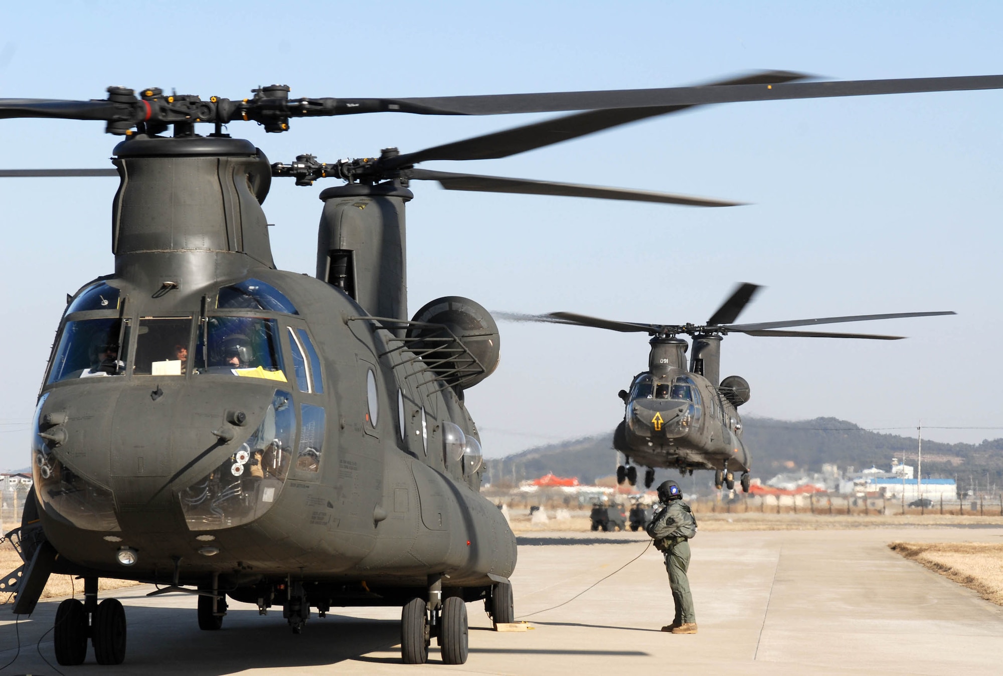 KUNSAN AIR BASE, South Korea -- Two CH-47 Chinook helicopter's land here Mar 1. The Chinook's arrived from Camp Humphrey's, Bravo Company 4-2, as part of the Key Resolve/Foal Eagle exercise, enhancing combat readiness and joint interoperability.  (U.S. Air Force photo/Senior Airman Steven R. Doty) 
