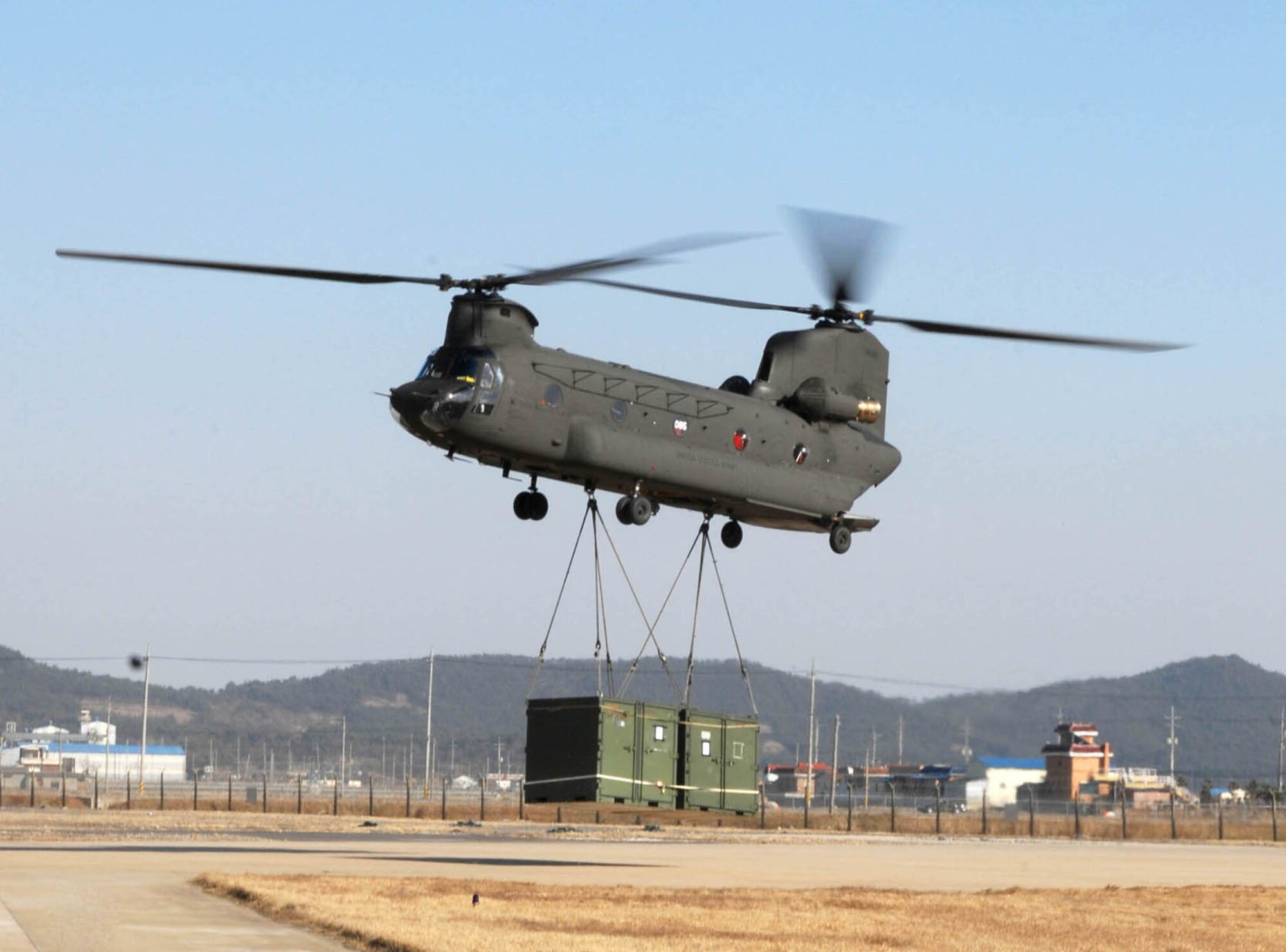 KUNSAN AIR BASE, South Korea -- A CH-47 Chinook helicopter drops off troops, vehicles and additional supplies here Mar. 1.  The Chinook arrived from Camp Humphrey's, Bravo Company 4-2, as part of the Key Resolve/Foal Eagle exercise, enhancing combat readiness and joint interoperability.  (U.S. Air Force photo/Senior Airman Steven R. Doty) 
