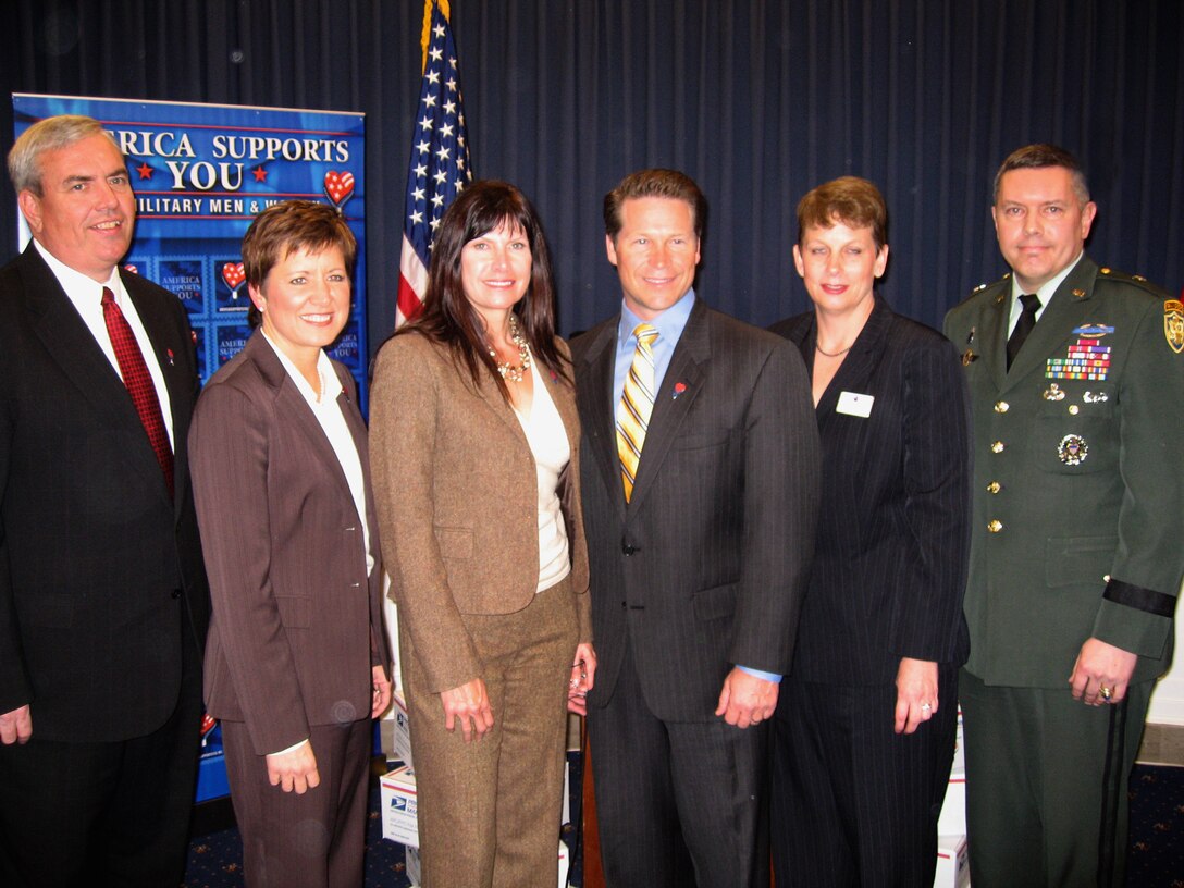 From left: John E. Potter, U.S. postmaster general, Allison Barber, deputy assistant secretary of defense for internal communications and public liaison, Rep. Mary Bono Mack of California and Rep. Connie Mack of Florida,  Karen Grimord, founder and president of the Landstuhl Hospital Care Project, and Army Brig. Gen. Gary Patton, director of manpower and personnel for the Joint Chiefs of Staff office and an America Supports You spokesman, pose for a picture during the America Supports You Caucus March 5, 2008, in Washington, D.C. Defense Dept. photo by John J. Kruzel