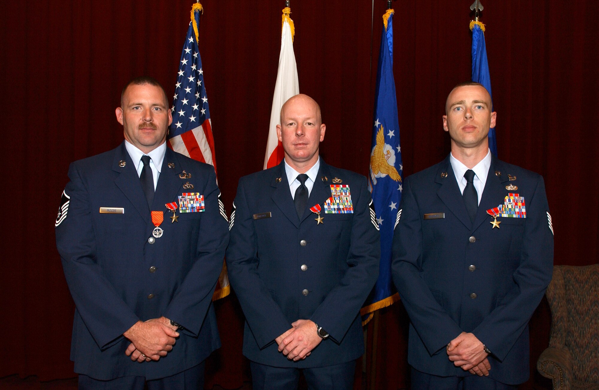 (from left) Master Sgt’s. Douglas Moore and Christopher Pollock, and Tech. Sgt. Stephen McGrath, all with the18th Civil Engineer Squadron, received the Bronze Star Medal in a ceremony at the Officers Club Feb. 27. Sergeant Moore was  also presented with the new Air Force Combat Action Medal for his actions while returning enemy fire in support of Operation Iraqi Freedom.
(U.S. Air Force photo/Senior Airman Jeremy McGuffin) 