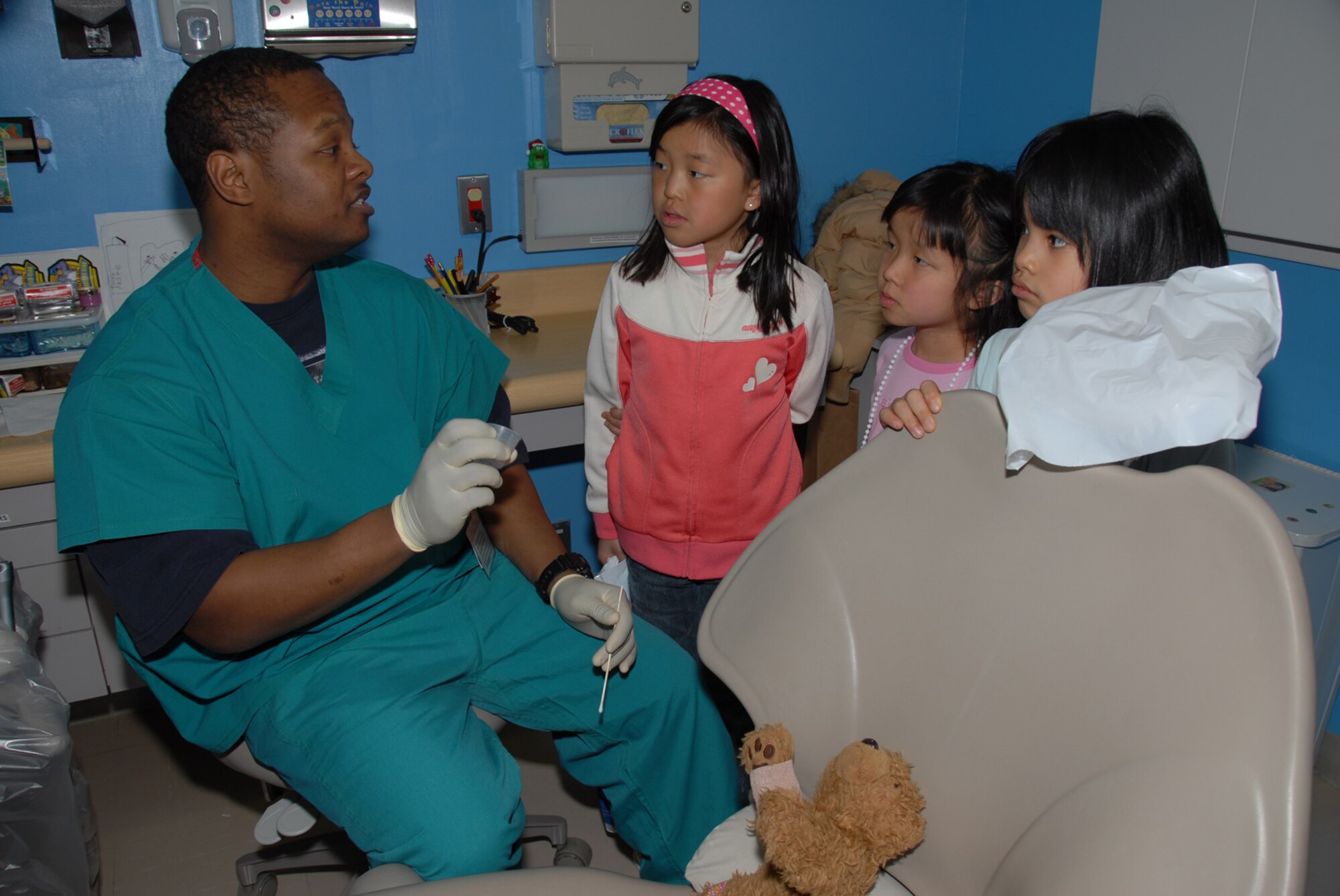 MISAWA AIR BASE, Japan -- Staff Sgt. Adrian Outlaw, 35th Dental Squadron, explains proper dental care to Misawa children during the annual Teddy Bear Clinic here on Mar. 1, 2008.  Children brought their stuffed animals to the base hospital to have them checked out by medical professionals.  The clinic is designed to give children a better understanding of hospitals and to help curb their fears of them.  (U.S. Air Force photo by Senior Airman Laura R. McFarlane)