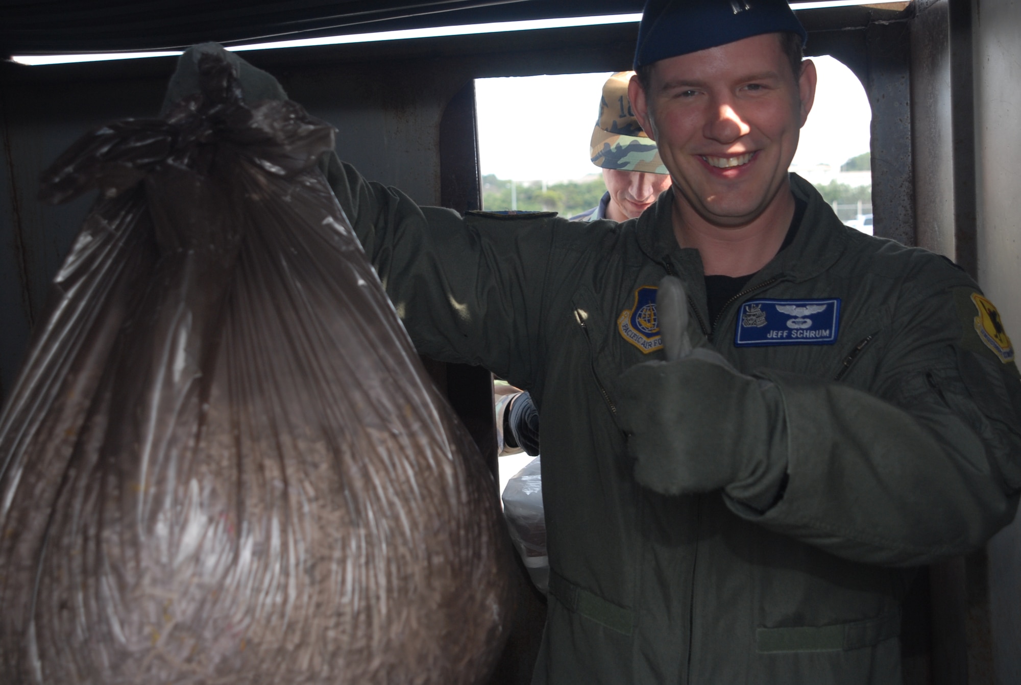 Capt. Jeffrey Schrum holds up a bag of properly shredded papers, highlighting a job well done when it comes to proper OPSEC procedures.  Members of the OPSEC office make random trips around base, ensuring that all the units of the 18th Wing are adhering to proper OPSEC practices.  (U.S. Air Force photo/Staff Sgt. Christopher Marasky)