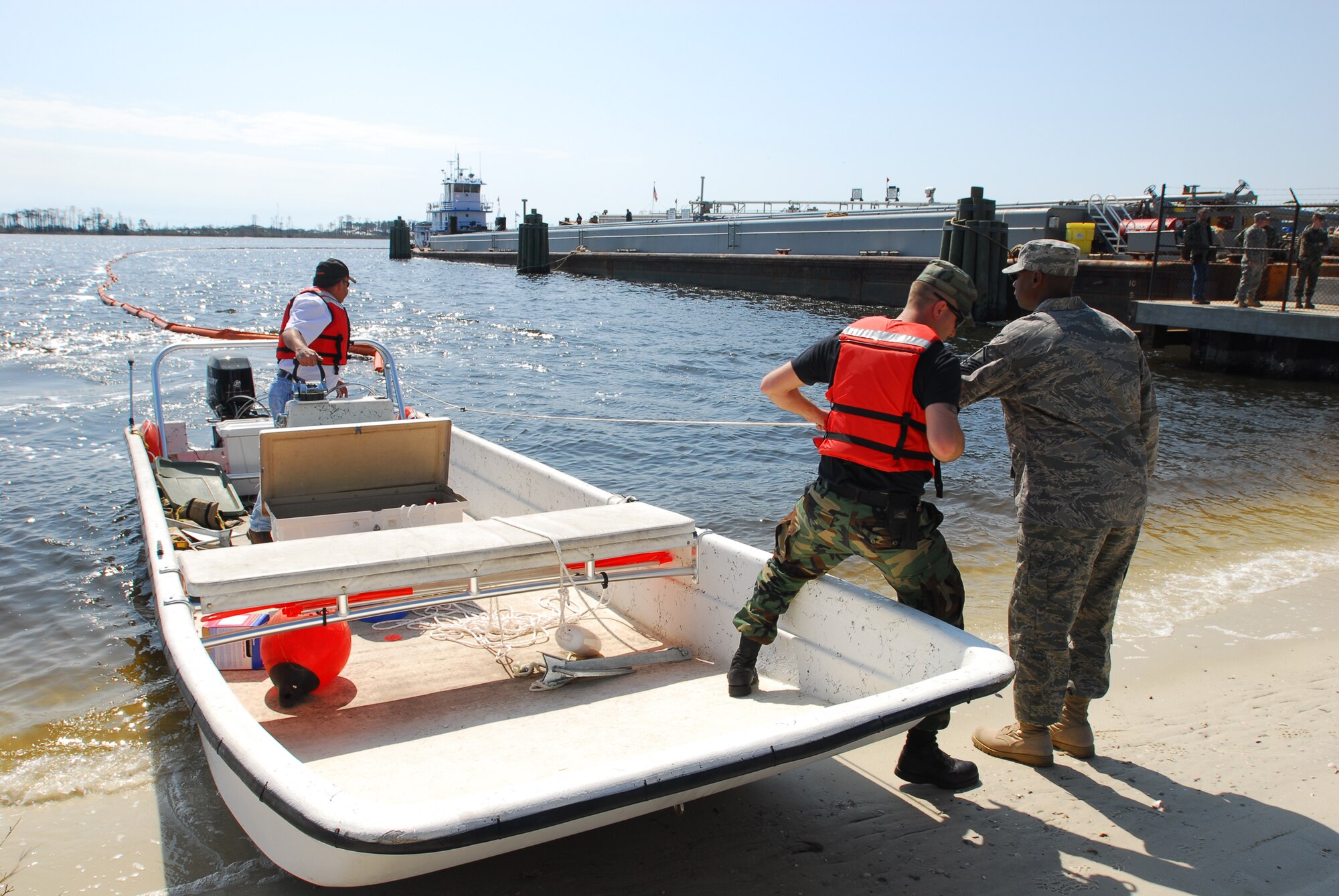 Airmen from the 1st Special Operations Logistics Readiness Squadron secure a protective boom to an anchoring point next to the fuel pier on Hurlburt Field March 6. In case of a fuel leak the boom would contain the spill preventing damage to protected wetlands on Santa Rosa Sound. The newly constructed, $5.3 million fuel pier accepted its first barge March 6. The fuel pier pumps fuel to Hurlburt Field through an underground pipe, which will greatly increase the efficiency of delivering fuel to the base. The old fuel pier was destroyed during Hurricane Ivan in September 2004. (U.S. Air Force photo/Airman 1st Class Jason Epley)