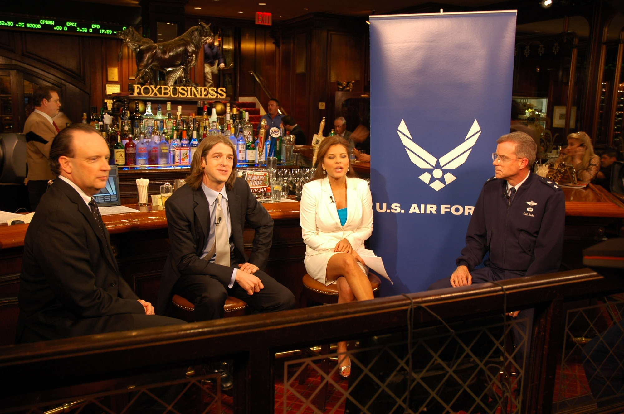 Air Force officials talk green issues on Fox Business Channel's, "Happy Hour."  Assistant Secretary of the Air Force Bill Anderson (left) and Maj. Gen. Curtis Bedke, Air Force Research Laboratory commander, chat with hosts Cody Willard and Rebecca Gomez about Air Force plans to save money and the environment through renewable energy sources including wind, sun and coal.  The Air Force currently spends almost $6 billion on energy annually.  (U.S. Air Force photo/Tech. Sgt. Rebecca Danet)