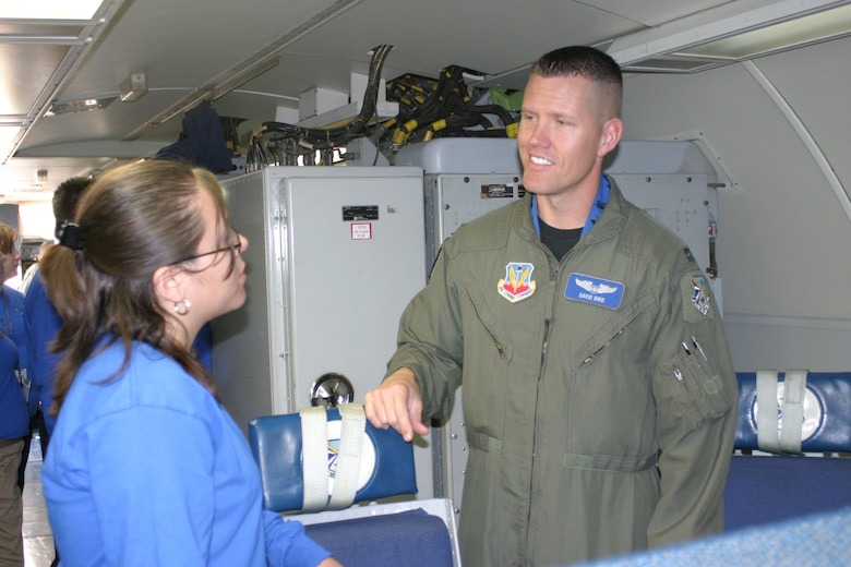 Captain David R. Bird, 966th Airborne Air Control Squadron teaches Ana Flores about being an Air Weapons Officer. Photo by 2nd Lt. Kinder L. Blacke.