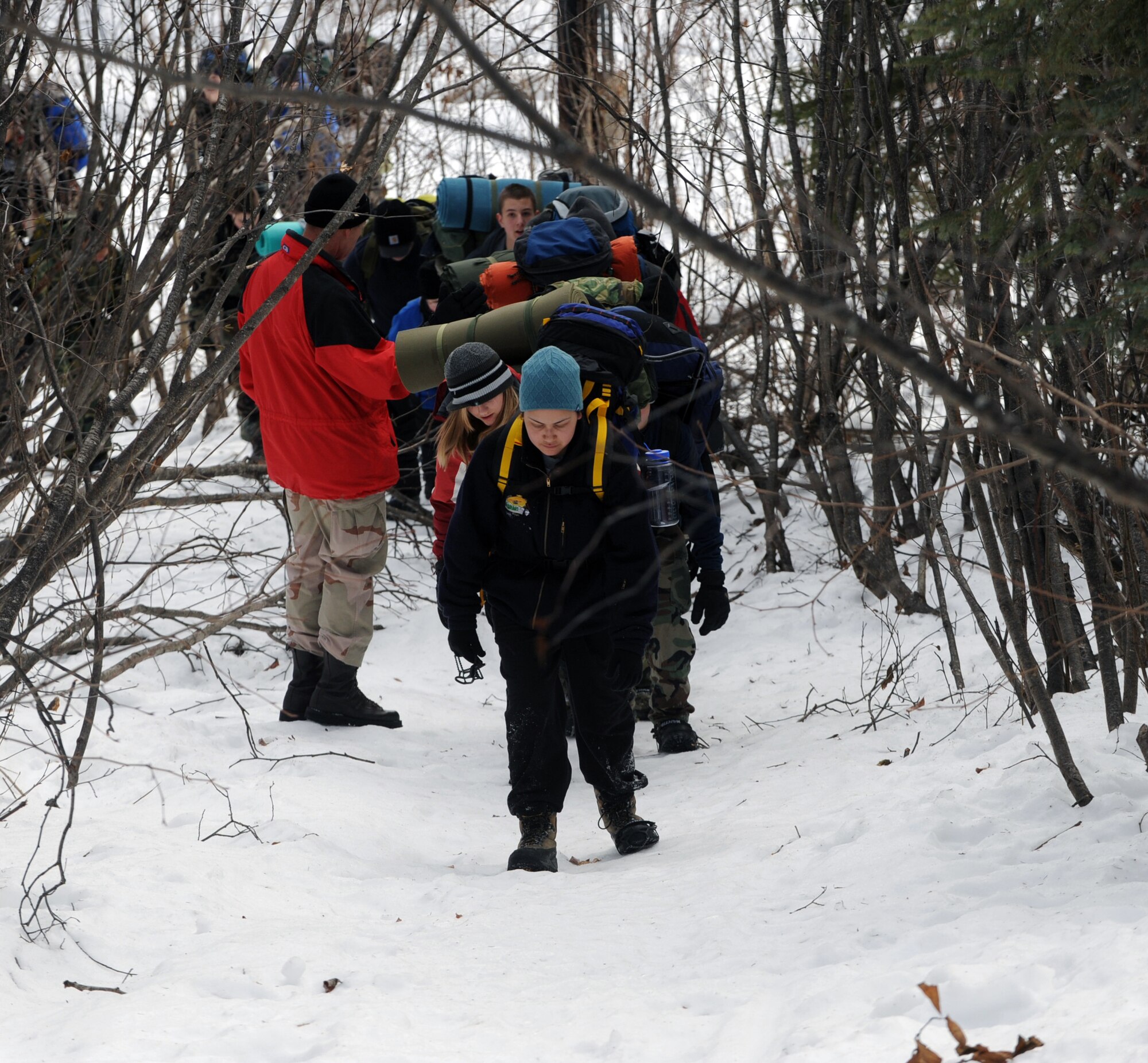 Cadets of the Eagle River and West High School Junior ROTC march the eight-mile trail from the Fort Richardson Military Youth Academy to Upper Otter Lake. Several cadets carried more than 50 pounds of gear on their back during the hike to the lake. (U.S. Air Force photo by Airman 1st Class Matt Owens)