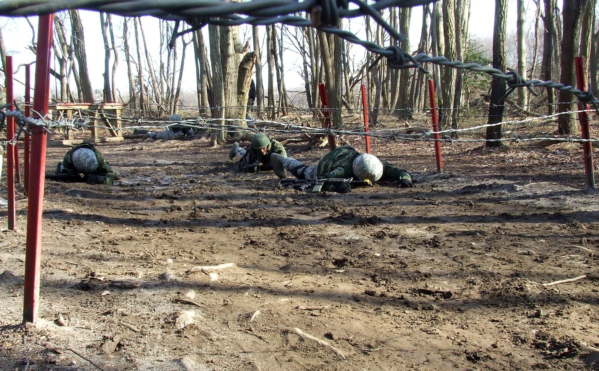 Students go through the combat first aid obstacle course on a range on Fort Dix, N.J., Feb. 29, 2008, as part of training in the U.S. Air Force Expeditionary Center's Air Advisor Course 08-1.  The course, taught by the Center's Expeditionary Operations School, is the first of its kind for the Center and is preparing Airmen deploying to Afghanistan and Iraq who will in turn be training military forces in those countries.  (U.S. Air Force Photo/Tech. Sgt. Scott T. Sturkol)
