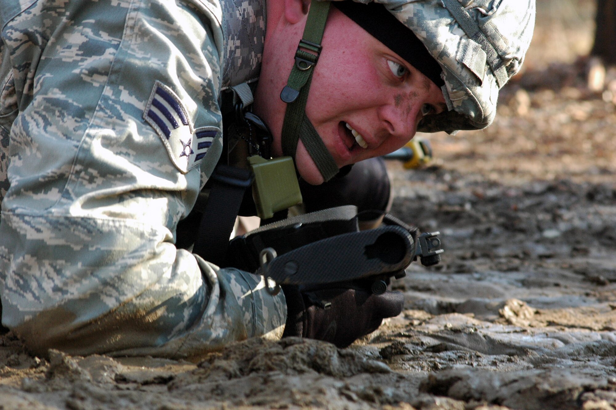 Senior Airman Joshua Roden and other students go through the combat first aid obstacle course on a range on Fort Dix, N.J., Feb. 29, 2008, as part of training in the U.S. Air Force Expeditionary Center's Air Advisor Course 08-1.  The course, taught by the Center's Expeditionary Operations School, is the first of its kind for the Center and is preparing Airmen deploying to Afghanistan and Iraq who will in turn be training military forces in those countries.  Airman Roden is from Robins Air Force Base, Ga.  (U.S. Air Force Photo/Tech. Sgt. Scott T. Sturkol)