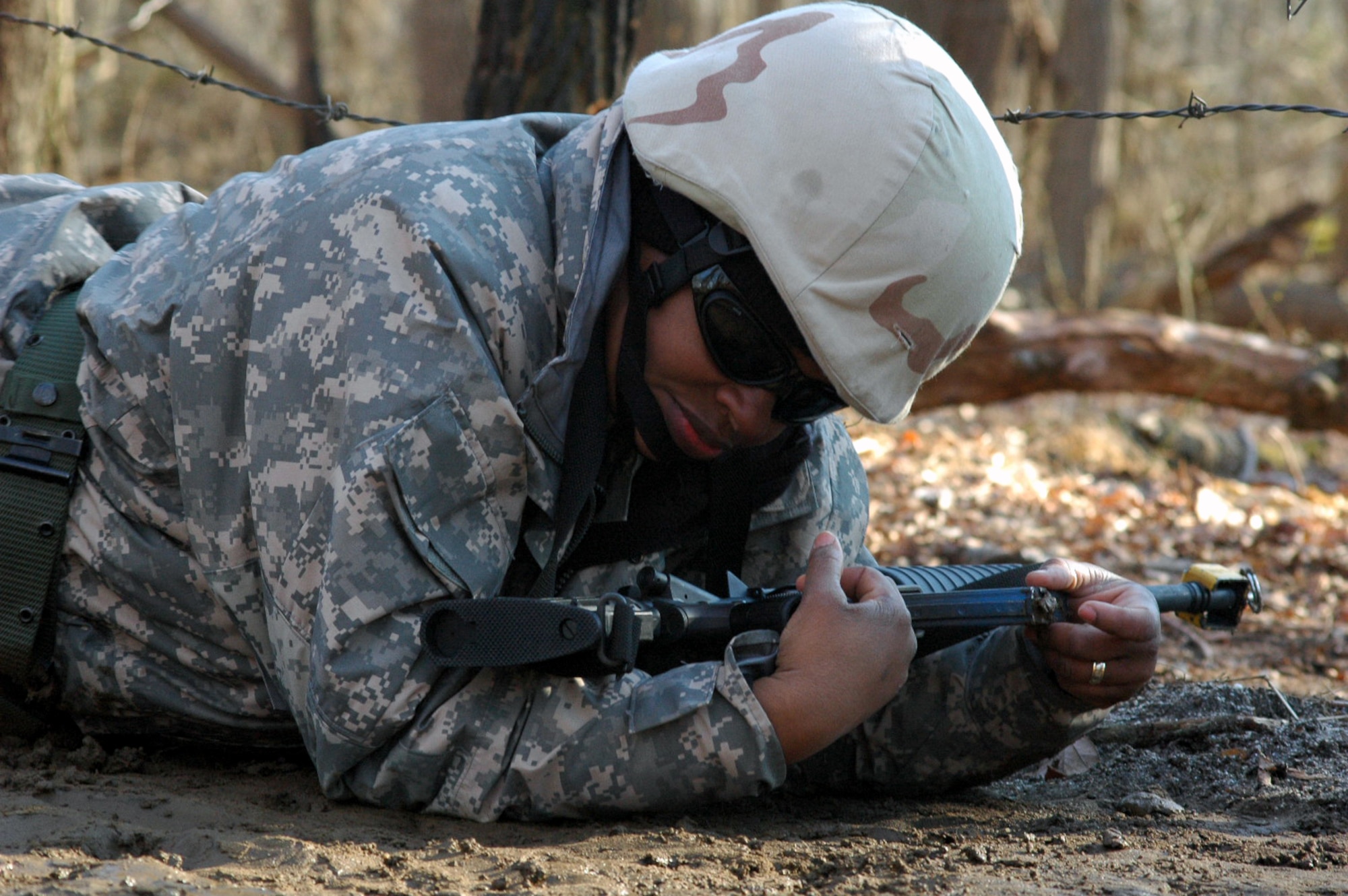 Capt. Dianne Dreesman goes through the combat first aid obstacle course on a range on Fort Dix, N.J., Feb. 29, 2008, as part of training in the U.S. Air Force Expeditionary Center's Air Advisor Course 08-1.  The course, taught by the Center's Expeditionary Operations School, is the first of its kind for the Center and is preparing Airmen deploying to Afghanistan and Iraq who will in turn be training military forces in those countries.  Captain Dreesman is from Goodfellow Air Force Base, Texas.  (U.S. Air Force Photo/Tech. Sgt. Scott T. Sturkol)