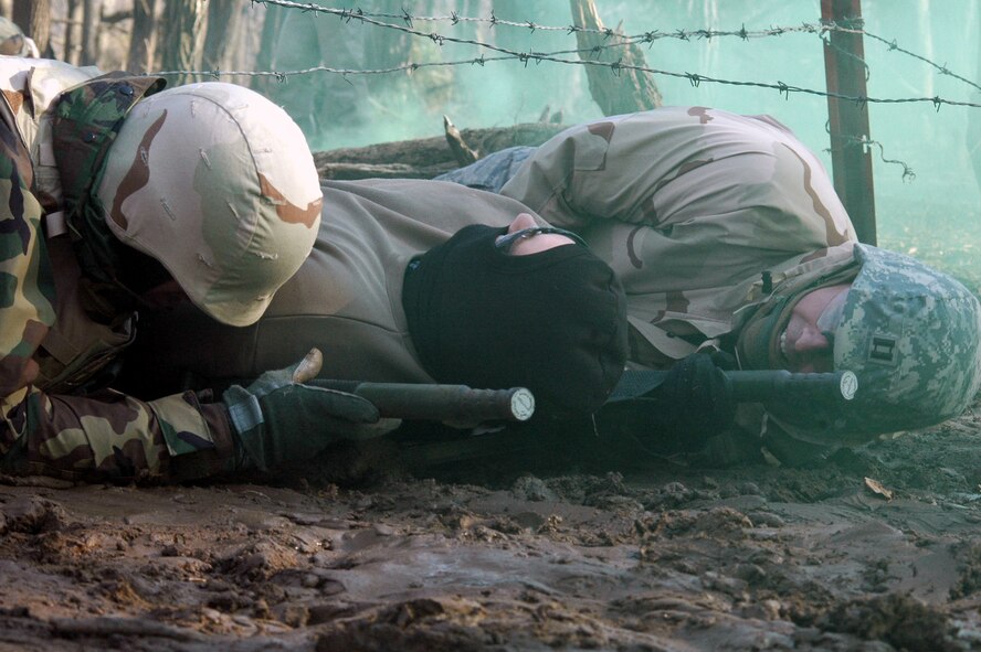 Students go through the combat first aid obstacle course on a range on Fort Dix, N.J., Feb. 29, 2008, as part of training in the U.S. Air Force Expeditionary Center's Air Advisor Course 08-1.  The course, taught by the Center's Expeditionary Operations School, is the first of its kind for the Center and is preparing Airmen deploying to Afghanistan and Iraq who will in turn be training military forces in those countries.  (U.S. Air Force Photo/Tech. Sgt. Scott T. Sturkol)