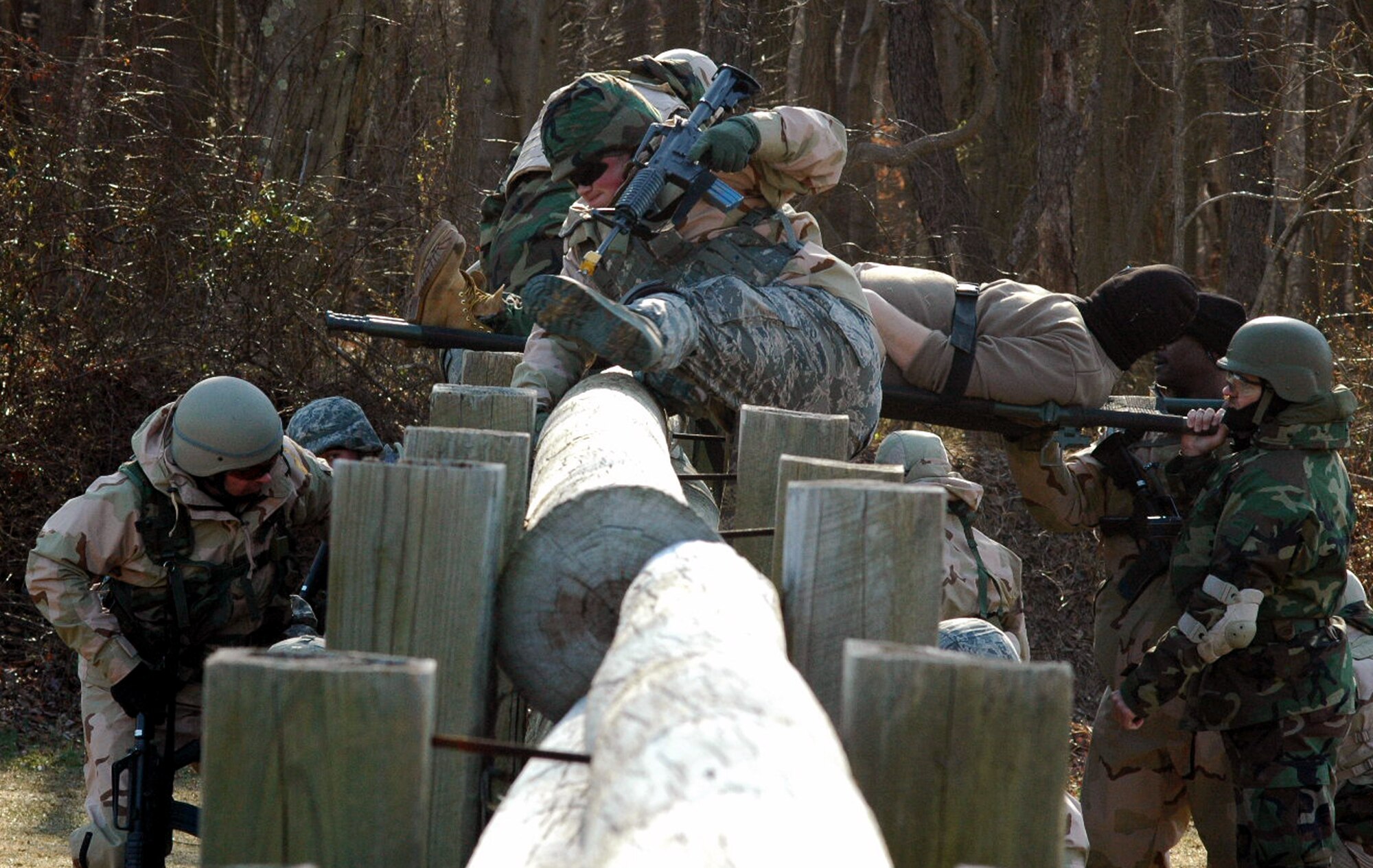 Students go through the combat first aid obstacle course on a range on Fort Dix, N.J., Feb. 29, 2008, as part of training in the U.S. Air Force Expeditionary Center's Air Advisor Course 08-1.  The course, taught by the Center's Expeditionary Operations School, is the first of its kind for the Center and is preparing Airmen deploying to Afghanistan and Iraq who will in turn be training military forces in those countries.  (U.S. Air Force Photo/Tech. Sgt. Scott T. Sturkol)