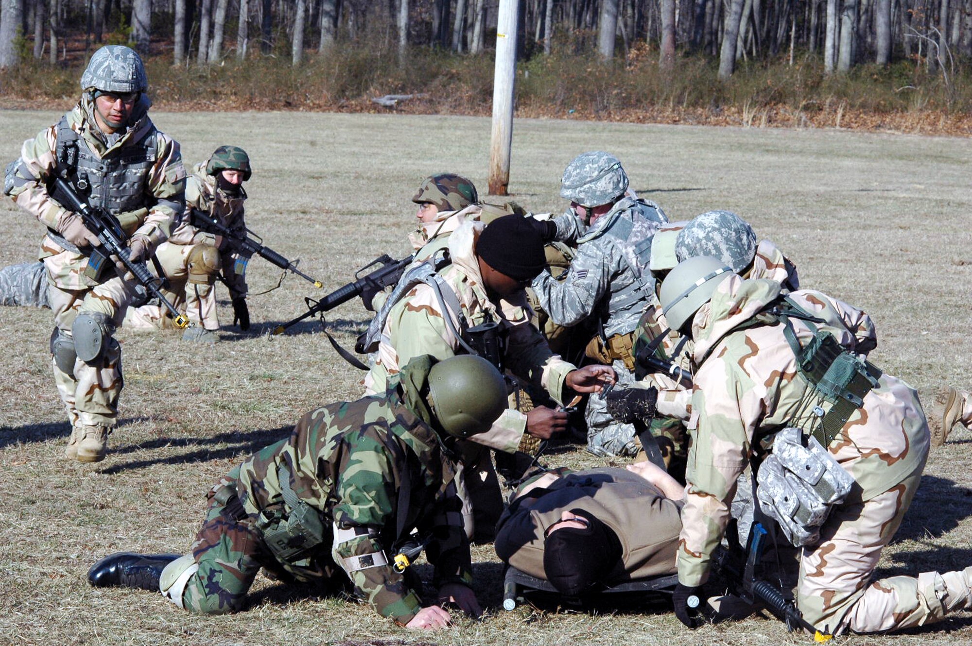 Students go through the combat first aid obstacle course on a range on Fort Dix, N.J., Feb. 29, 2008, as part of training in the U.S. Air Force Expeditionary Center's Air Advisor Course 08-1.  The course, taught by the Center's Expeditionary Operations School, is the first of its kind for the Center and is preparing Airmen deploying to Afghanistan and Iraq who will in turn be training military forces in those countries.  (U.S. Air Force Photo/Tech. Sgt. Scott T. Sturkol)