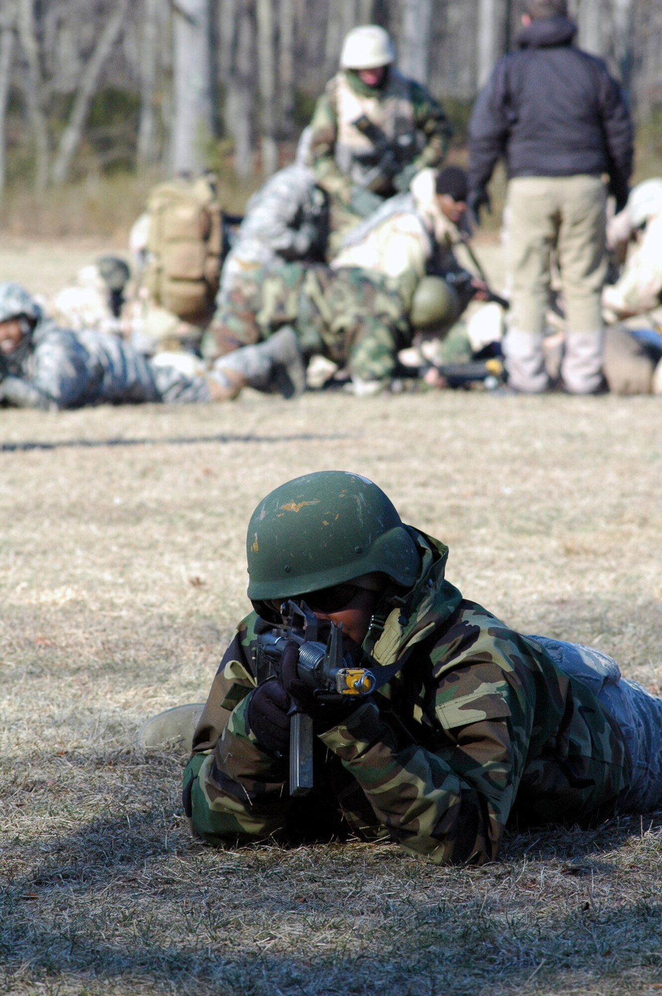 Staff Sgt. Saul Bookman and other students go through the combat first aid obstacle course on a range on Fort Dix, N.J., Feb. 29, 2008, as part of training in the U.S. Air Force Expeditionary Center's Air Advisor Course 08-1.  The course, taught by the Center's Expeditionary Operations School, is the first of its kind for the Center and is preparing Airmen deploying to Afghanistan and Iraq who will in turn be training military forces in those countries.  Sergeant Bookman is from Lackland Air Force Base, Texas.  (U.S. Air Force Photo/Tech. Sgt. Scott T. Sturkol)