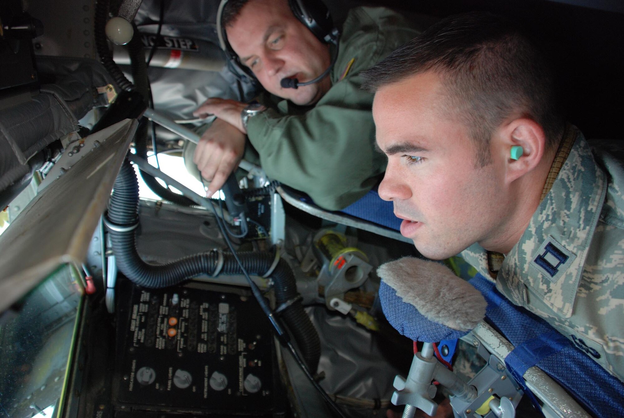 Staff Sgt. Kenneth Clonts, 756th Air Refueling Squadron boom operator, shows Capt. Eric DeTurk, 316th Security Forces Squadron section commander, how the flying boom works on a KC-135 Stratotanker during an incentive flight on Feb. 29, over the coast of North Carolina. The KC-135 Stratotanker's principal mission is air refueling. The KC-135 is also capable of transporting litter and ambulatory patients using patient support pallets during aeromedical evacuations. (US Air Force/A1C Andrew Polvino)