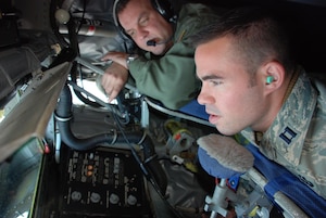 Staff Sgt. Kenneth Clonts, 756th Air Refueling Squadron boom operator, shows Capt. Eric DeTurk, 316th Security Forces Squadron section commander, how the flying boom works on a KC-135 Stratotanker during an incentive flight on Feb. 29, over the coast of North Carolina. The KC-135 Stratotanker's principal mission is air refueling. The KC-135 is also capable of transporting litter and ambulatory patients using patient support pallets during aeromedical evacuations. (US Air Force/A1C Andrew Polvino)