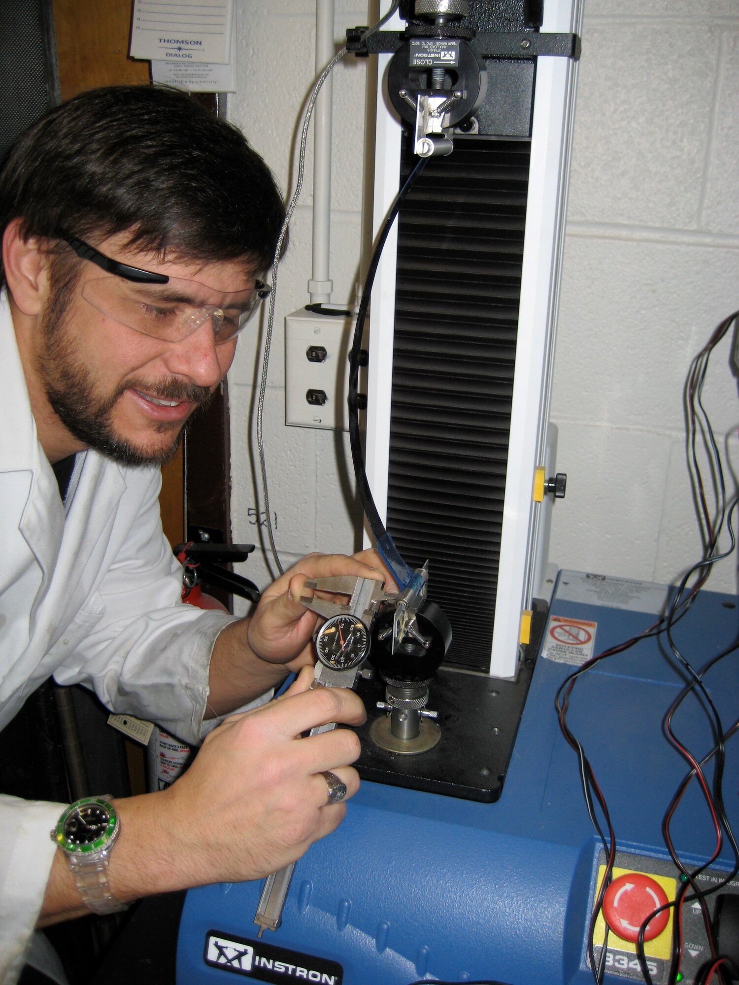 Dr. Barrett-Gonzalez checks lateral clearance on an adaptive missile fin flight control actuator during a blocked force and deflection test. (Photo provided)