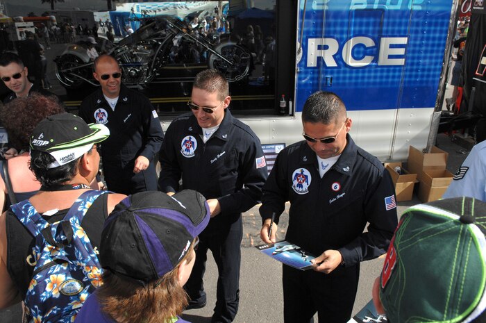 LAS VEGAS--Members of the U.S. Air Force Aerial Demonstration Team, the Thunderbirds, sign autographs for NASCAR fans while outside the Las Vegas Motor Speedway during the Nationwide Series Sam's Town 300 here March 1. For more than a decade, the Nellis AFB community and Las Vegas Motor Speedway family have enjoyed a cooperative relationship that both thrills race fans and emblazons the patriotic spirit of America. (U.S. Air Force photo/Master Sgt Robert W. Valenca)