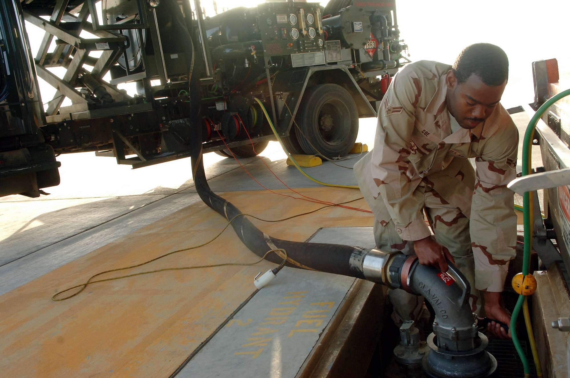 Airman 1st Class Zechariah Coe connects a fuel hose from an R12 Hydrant Servicing vehicle to an underground fuel storage tank Feb. 25 in Southwest Asia. Airman Coe took on every refueling opportunity he could to pump the more than 3,573,989 gallons of fuel that was required to break the previous record for the largest amount of fuel pumped in a month. Airman Coe is a fuels distribution operator with the 380th Expeditionary Logistics Readiness Squadron. (U.S. Air Force photo) 