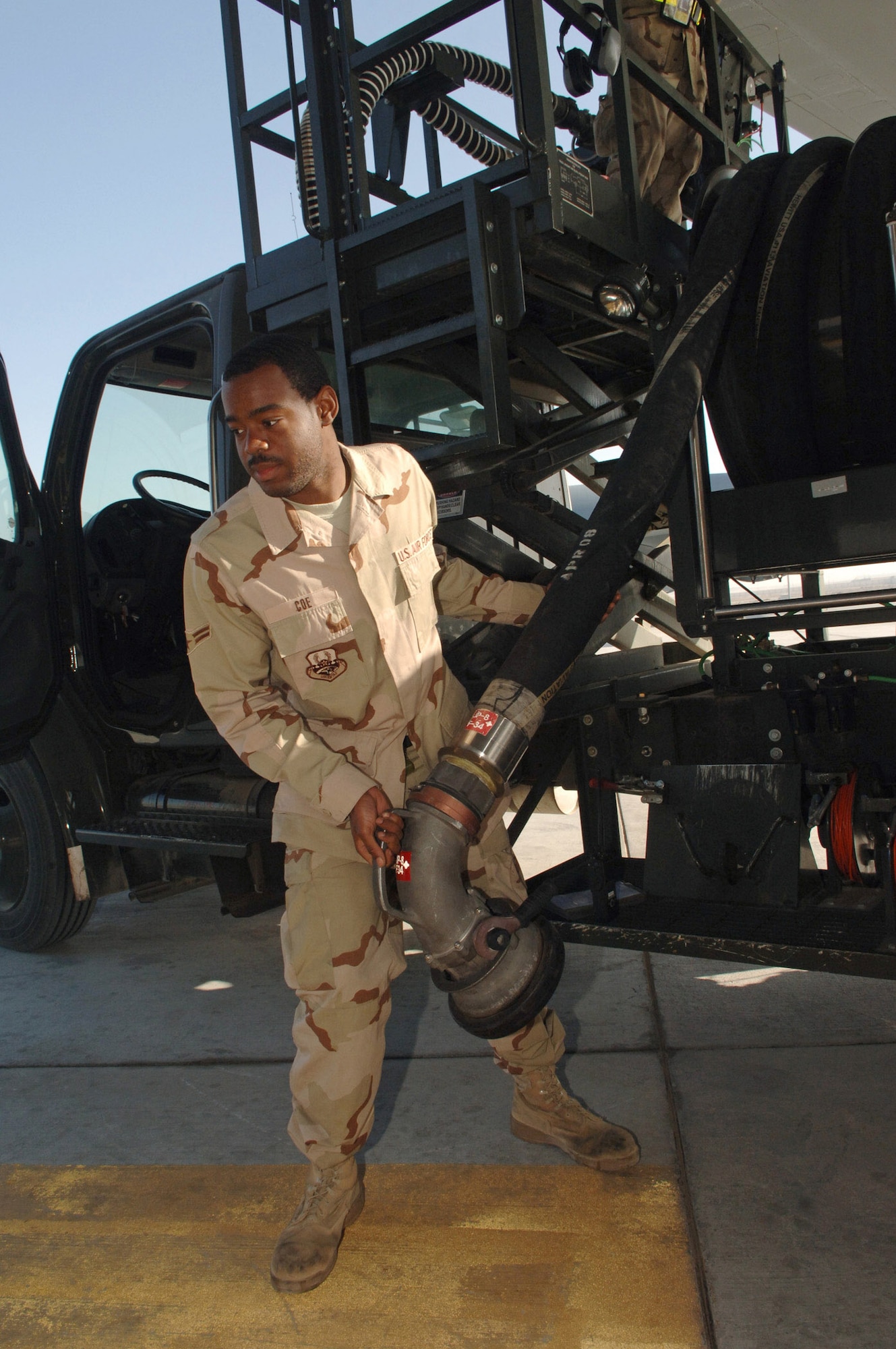 Airman 1st Class Zechariah Coe extends a fuel hose from an R12 Hydrant Servicing Vehicle to an underground fuel storage tank Feb. 25 in Southwest Asia.  Airman Coe took on every refueling opportunity he could to pump the more than 3,573,989 gallons of fuel breaking the previous record for fueled pumped in one month. Airman Coe is a fuels distribution operator with the 380th Expeditionary Logistics Readiness Squadron. (U.S. Air Force photo) 