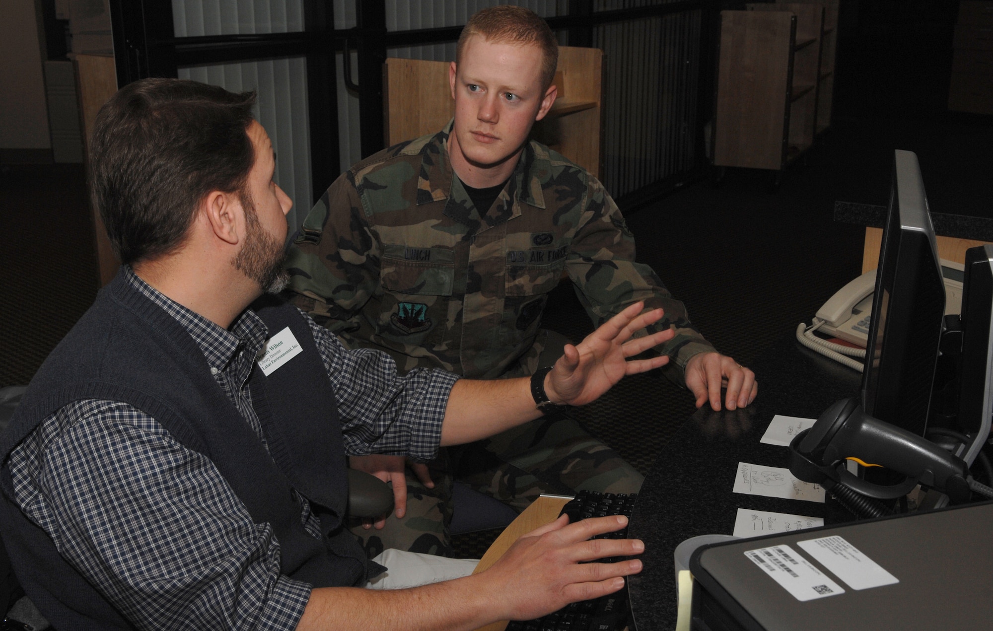 WHITEMAN AIR FORCE BASE, Mo. – Dennis Wilson, library director, explains how to use Air Combat Command’s Library Program Research Center to Airman 1st Class Stephen Linch, 509th Bomb Wing Public Affairs, at the base library March 5. (U.S. Air Force photo/Senior Airman Jessica Snow)
