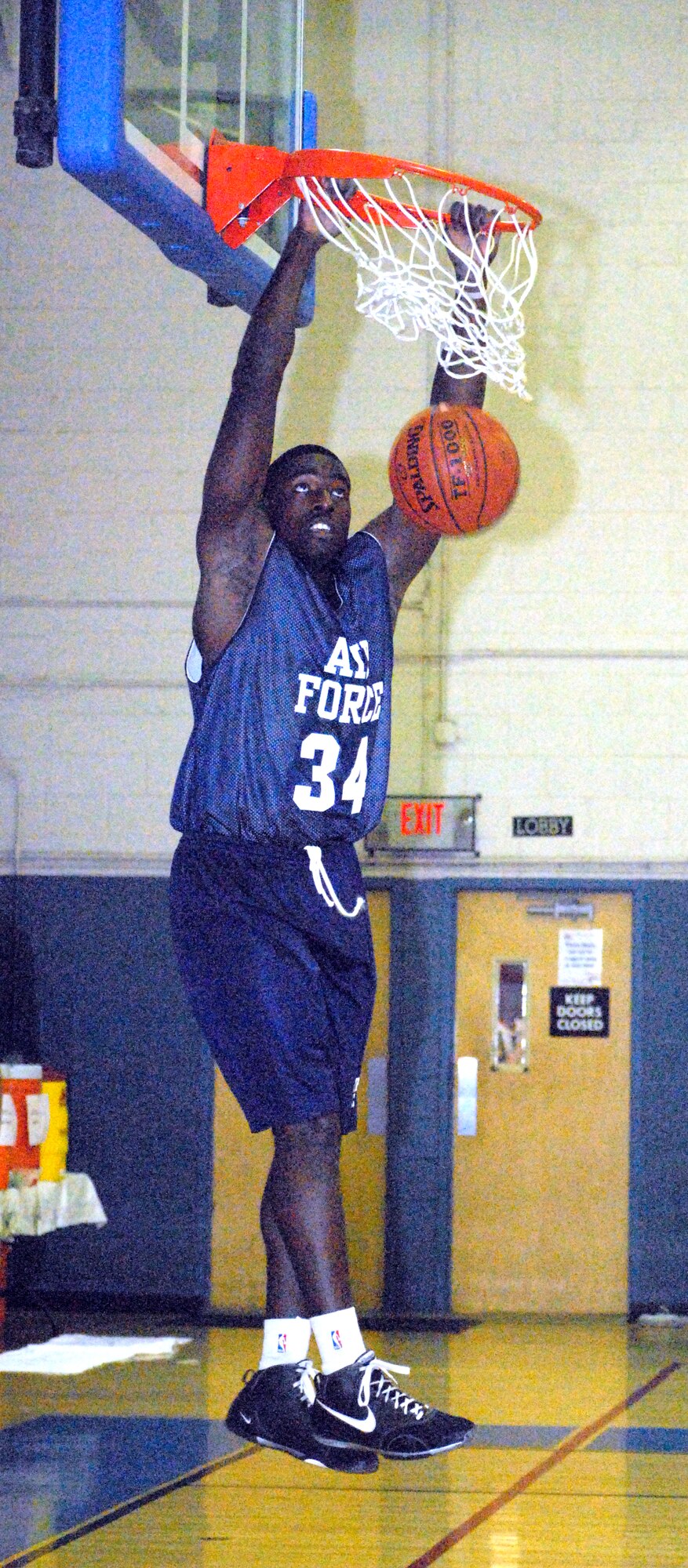 1st Lt. Dan Nwaelele, from Keesler Air Force Base, Miss., makes a slam dunk during a warm up session for the All Air Force Basketball try-outs in the Dover Air Force Base Fitness Center March 5. More than twenty Airmen from throughout the Air Force are competing throughout March for a coveted spot on the team. (U.S. Air Force photo/Airman 1st Class Shen-Chia Chu)