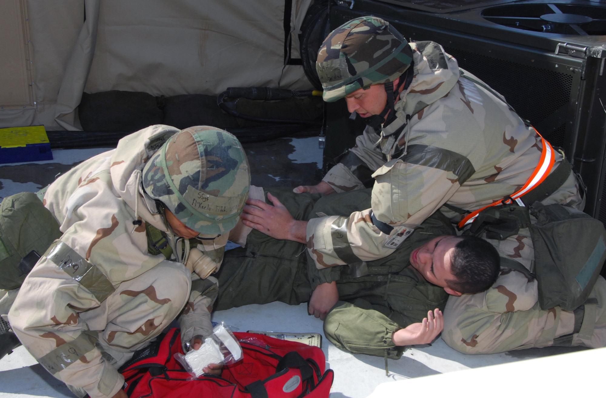 SSgt A'Keela Fitch and TSgt Jeff Jordon apply Self Aid Buddy Care  (SABC) to injured "victim" A1C Carlos Rivera. U. S. Air Force photo by Claude Lazzara
