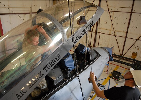 Airman First Class Christopher Nichols and Staff Sgt. Greg Frizalone, 56th Component Maintenance Squadron egress specialists, attach an actuator during a canopy installation on an F-16D, Mar. 3. (U.S. Air Force photo/Staff Sgt. Jerry Fleshman)