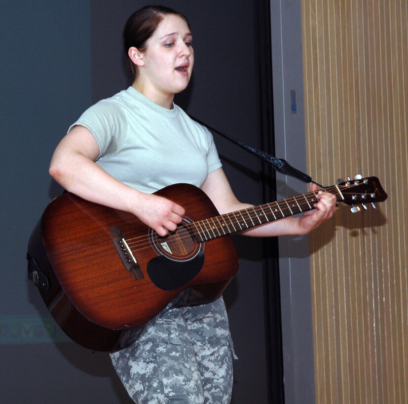 Pvt. Samantha Hinkley, a Soldier in D Company, 264th Medical Battalion at Sheppard Air Force Base, performs for "judges" at an All-Army Talent Show March 3. Private Hinkley won second place in the show. Pvt. Christopher McLaughlin took first place and Spc. Willard Willson won third. (U.S. Air Force photo/Lou Anne Sledge)