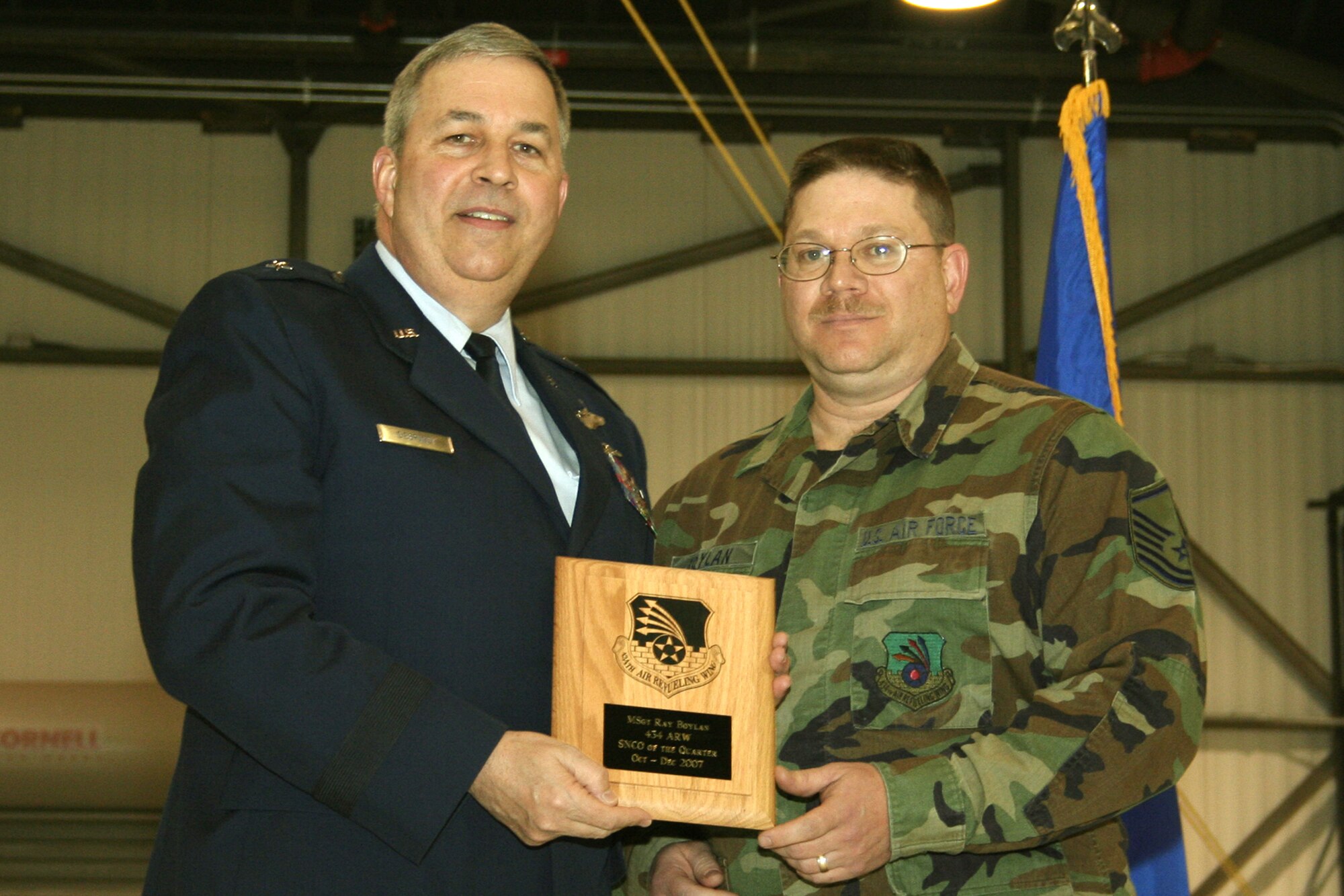 GRISSOM AIR RESERVE BASE, Ind., -- Brig. Gen. Dean Despinoy, 434th Air Refueling Wing commander, left, presents a plaque to Master Sgt. Ray Boylan, 434th Operations Support Squadron, for his selection as the 434th ARW's Senior NCO of the Quarter. The presentation was made during the wing commander's call held on the March unit training assembly. (U.S. Air Force photo/Tech. Sgt. Patrick Kuminecz)