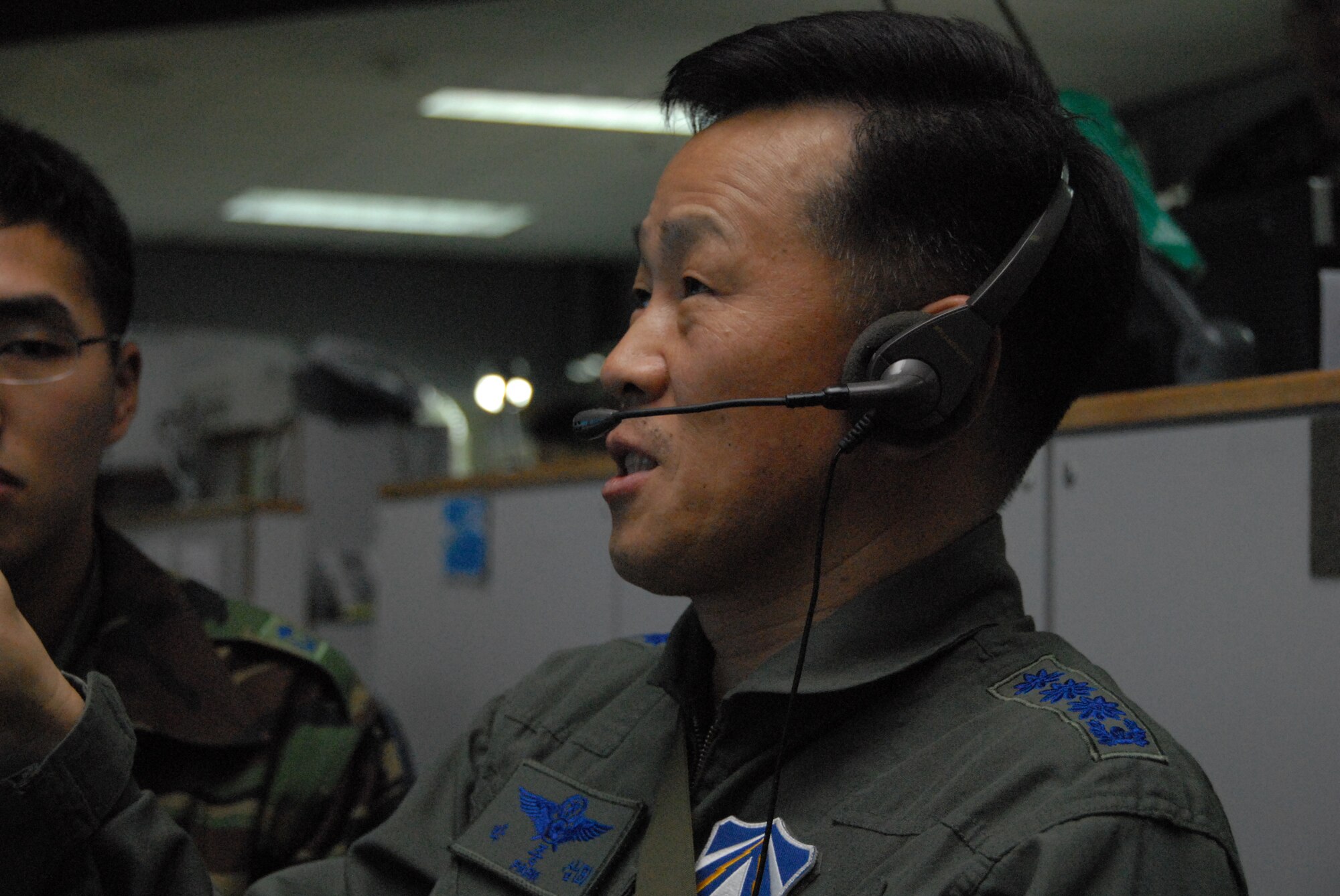 OSAN AIR BASE, Republic of Korea -- ROKAF Col. Park Jong Sam, chief of ROKAF combat operations oversees operations on the “pit floor” here in support of Exercise Key Resolve March 2 through 5. Key Resolve is an "operational-level," Republic of Korea-U.S. training exercise held peninsula-wide to ensure “operational” readiness of air, space and cyberspace operations in the Korean theater of operations. This annual exercise is held in conjunction with Foal Eagle 2008. Both exercises demonstrate U.S. resolve to support the Republic of Korea against external aggression while improving ROK/U.S. combat readiness and joint/combined interoperability. The “pit floor” is populated with people across a spectrum of specialties and service components where operational-level decisions take place.  (U.S. Air Force photo/Staff Sgt. Lakisha Croley)