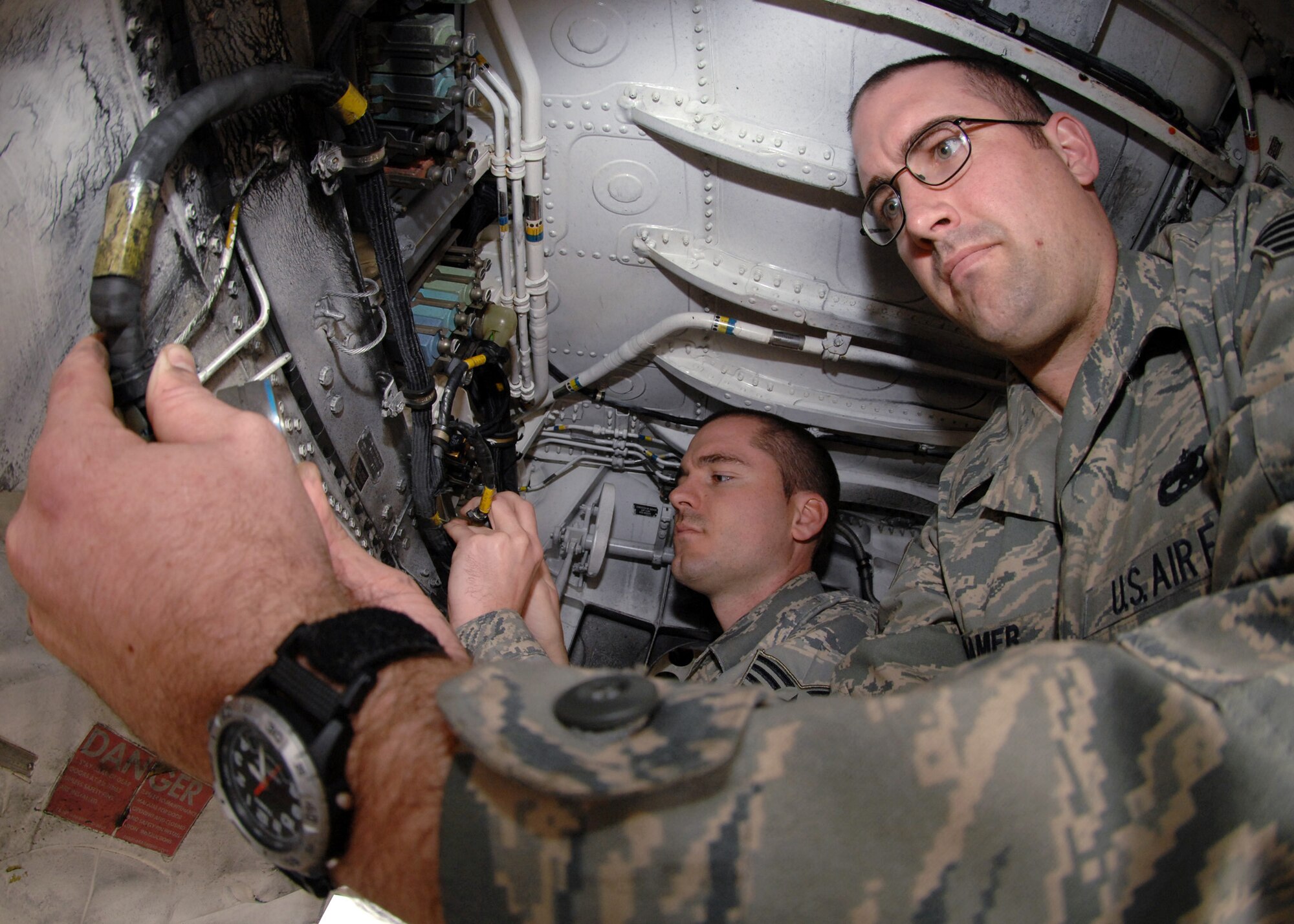 BAGRAM AIR BASE; Afghanistan - Staff Sgt. Robert Townson (left) and Staff Sgt. Jason Cramer, 455th Expeditionary Aircraft Maintenance Squadron, work on the right side electrical distribution harness on an F-15E. Sergeants Townson and Cramer, electro-environmental specialists, are deployed from the 335th Aircraft Maintenance Squadron, Seymour Johnson Air Force Base, N.C. (U.S. Air Force photo by Master Sgt. Demetrius Lester)