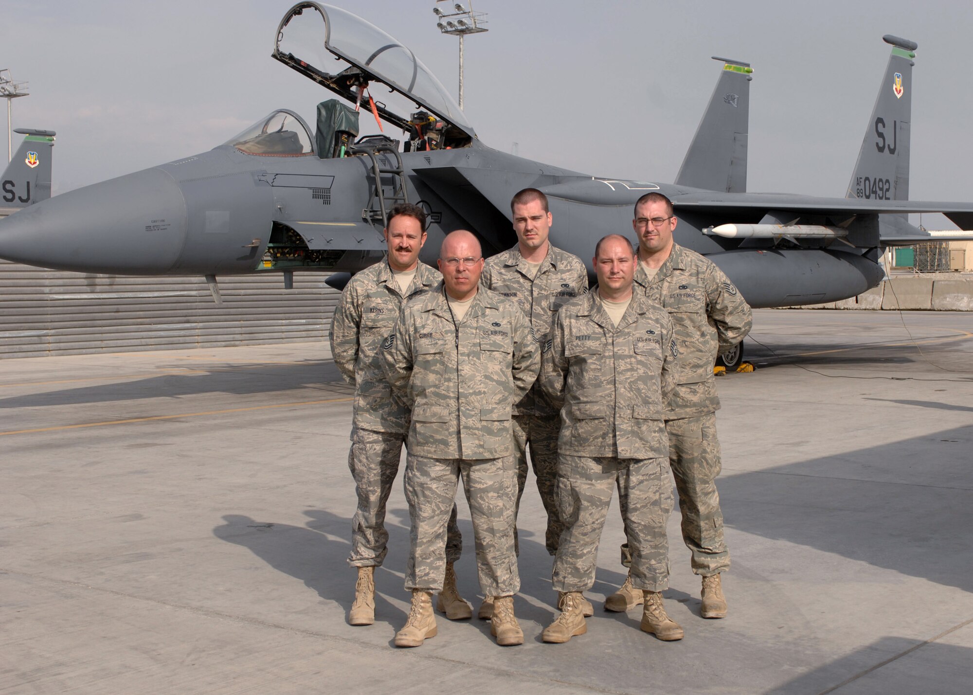 BAGRAM AIR BASE, Afghanistan - Members of the 455th Expeditionary Aircraft Maintenance Squadron pose for a photo in front of Aircraft 0492. The team worked on the aircraft 19 hours replacing a right side electrical distribution harness. The electro-environmental specialists are deployed from the 335th Aircraft Maintenance Squadron, Seymour Johnson Air Force Base, N.C. (U.S. Air Force photo by Master Sgt. Demetrius Lester)