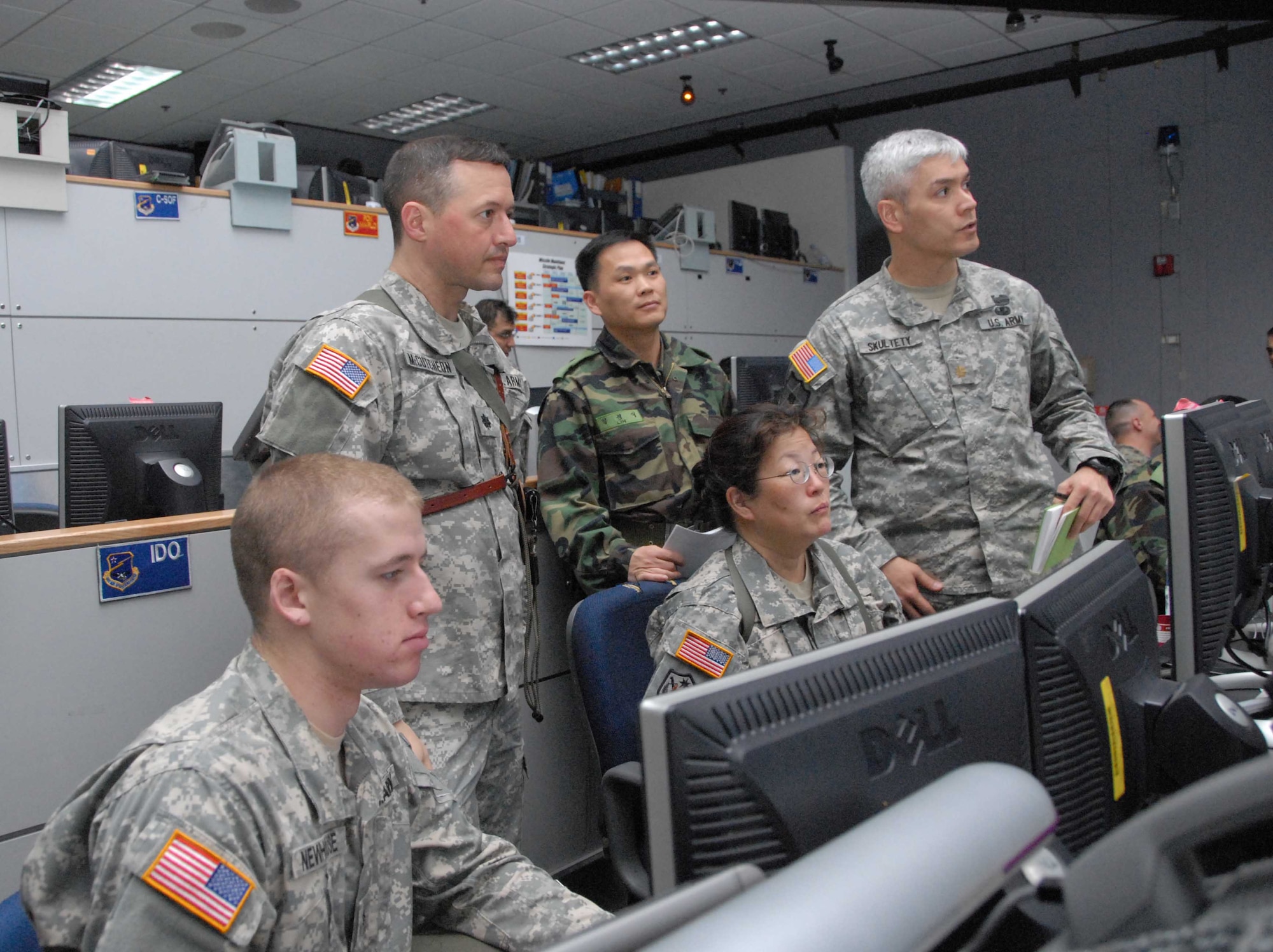 OSAN AIR BASE, Republic of Korea – Lt. Col. Philip McCutcheon, (standing, left), 3rd Battlefield Coordination Detachment-Korea, works along side Republic of Korea and U.S. servicemembers from various specialties and service components, across an entire spectrum where operational-level decisions take place. From Army, Navy and Marine Corps, to ROK, servicemembers bring coordination to the floor that allows full integration of massive air and space power with ROK-U.S. ground and sea operations. (U.S. Air Force photo/Staff Sgt. Lakisha Croley)