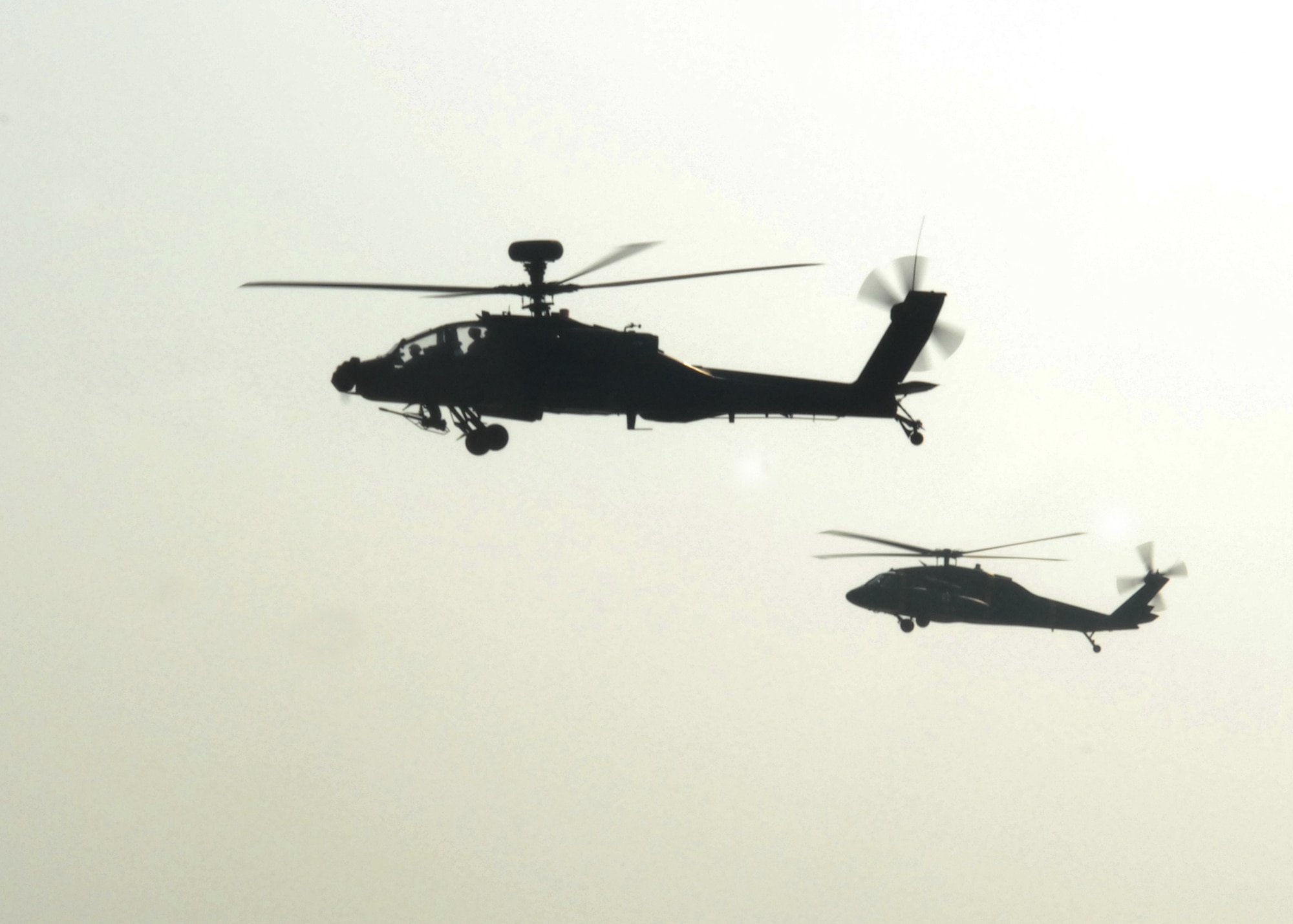 KUNSAN AIR BASE, South Korea -- An AH-64 Apache and a Army Blackhawk helicopters fly over the water here Mar. 6 Bravo Company, 4-2 Attack Battalion, 2nd Combat Aviation Brigade, is enhancing its primary mission of assisting the Naval Component Command, a combined United States and Republic of Korea element with a mission to suppress maritime targets. (U.S. Air Force Photo/Staff Sgt Araceli Alarcon) 