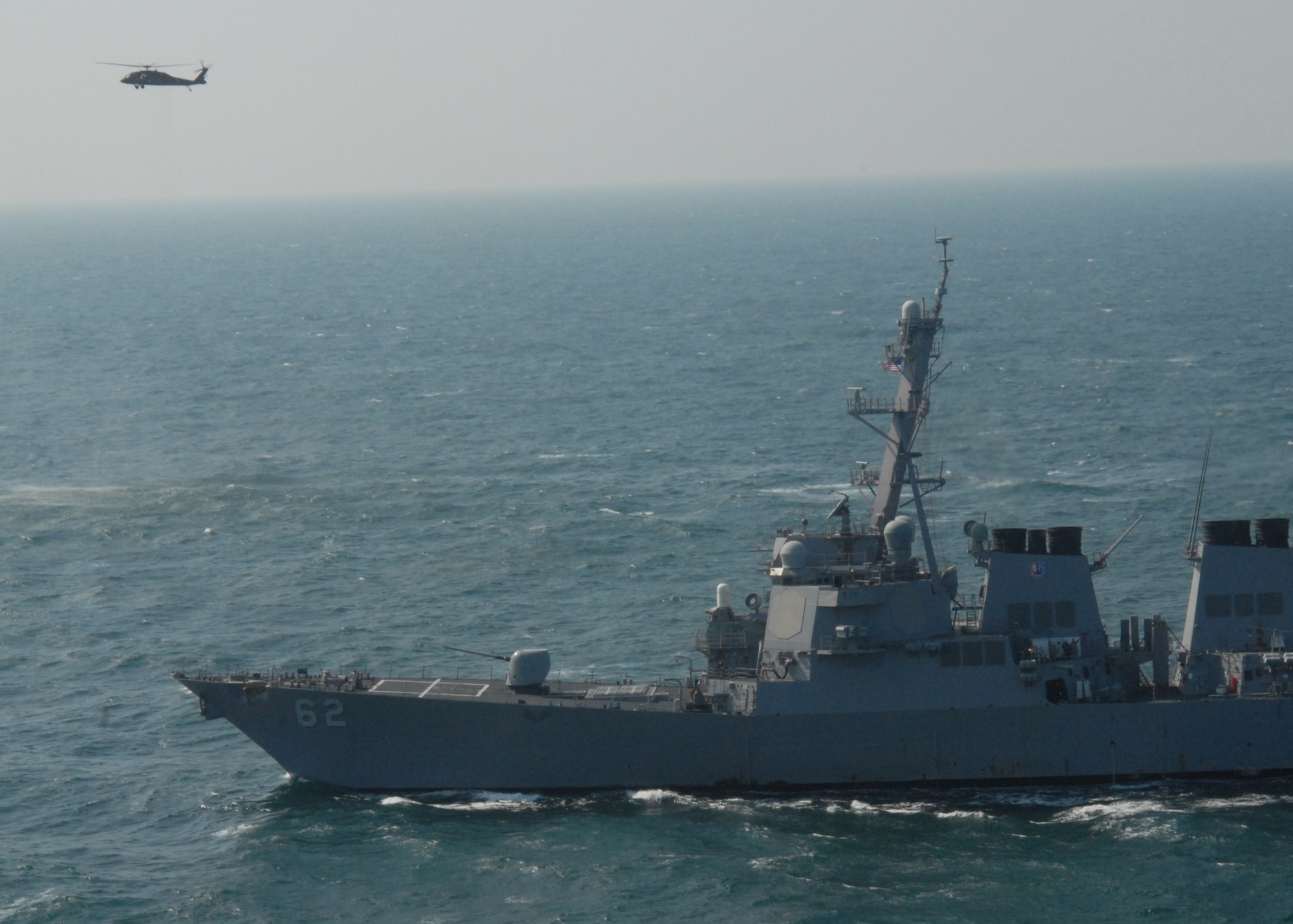 KUNSAN AIR BASE, South Korea -- An Army Blackhawk flies over the USS Fitzgerald here Mar. 6.  Bravo Company, 4-2 Attack Battalion, 2nd Combat Aviation Brigade, is enhancing its primary mission of assisting the Naval Component Command, a combined United States and Republic of Korea element with a mission to suppress maritime targets. (U.S. Air Force Photo/Staff Sgt Araceli Alarcon) 